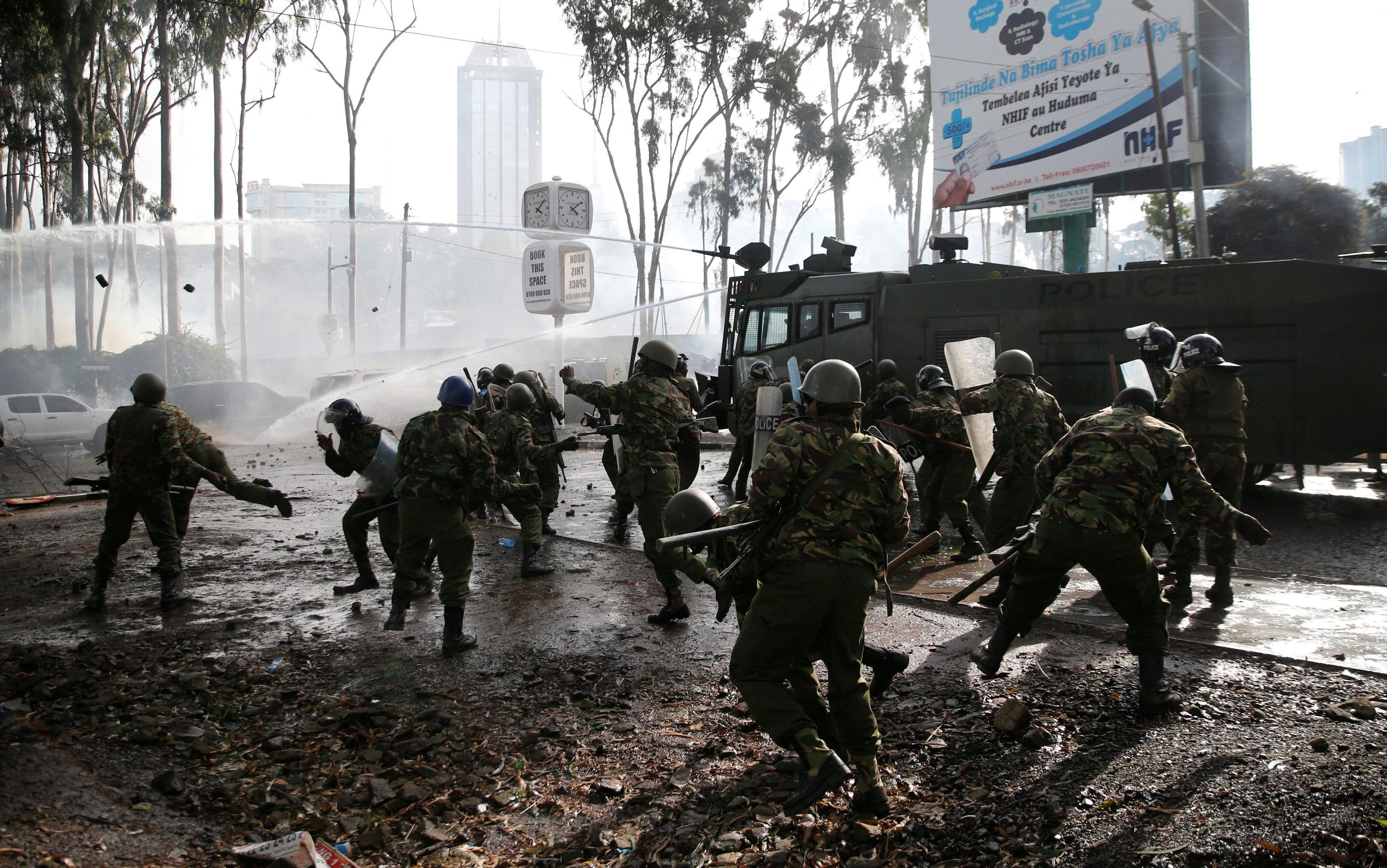 Riot police use stones to disperse the convoy of Kenyan opposition leader Raila Odinga of the Nation