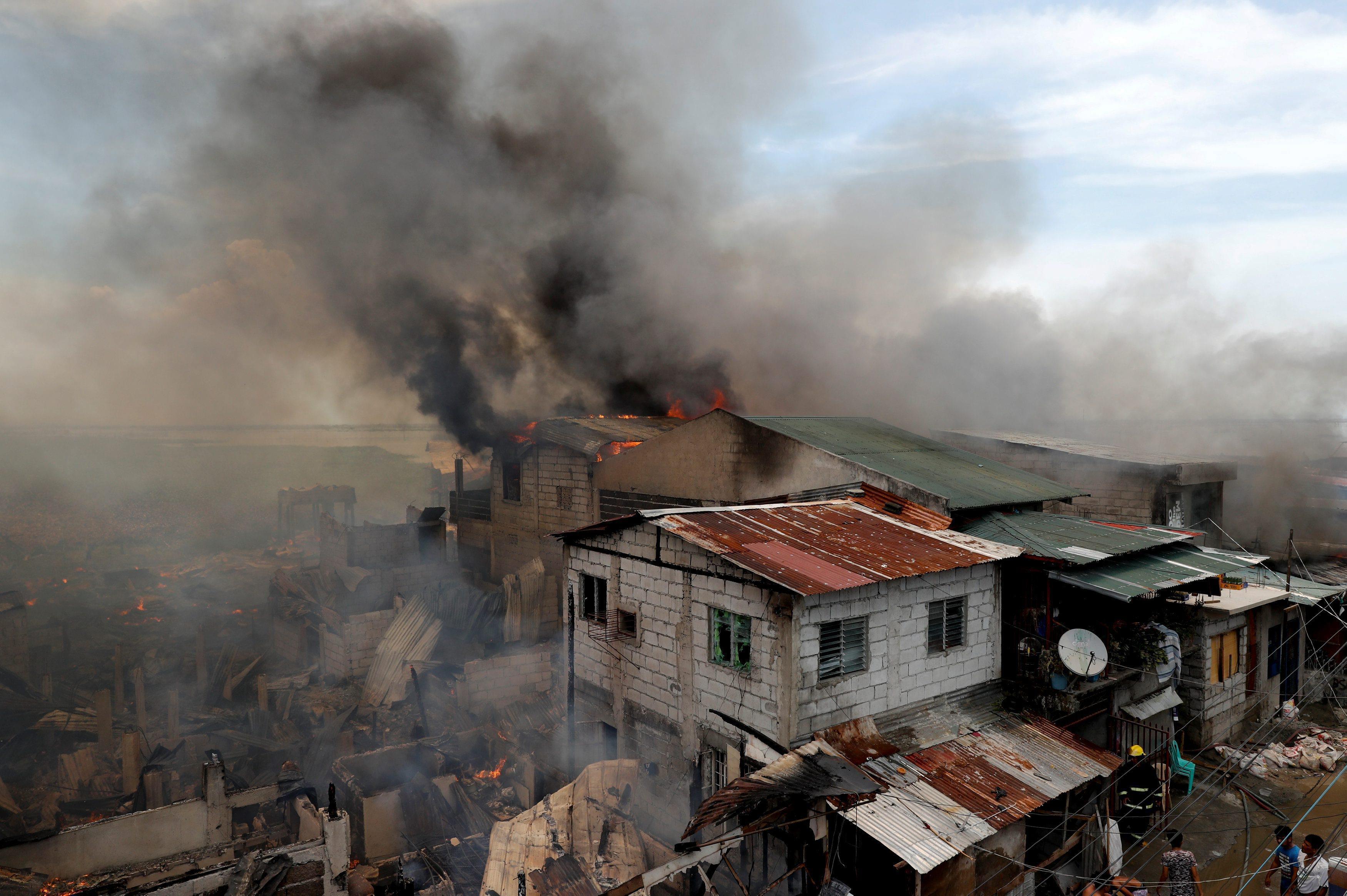 The Wider Image: Manila's slums an endless battle for firefighters