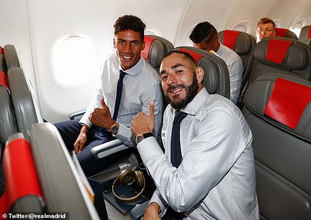 Raphael Varane (left) and Karim Benzema look relaxed after boarding the plane (Daily Mail)