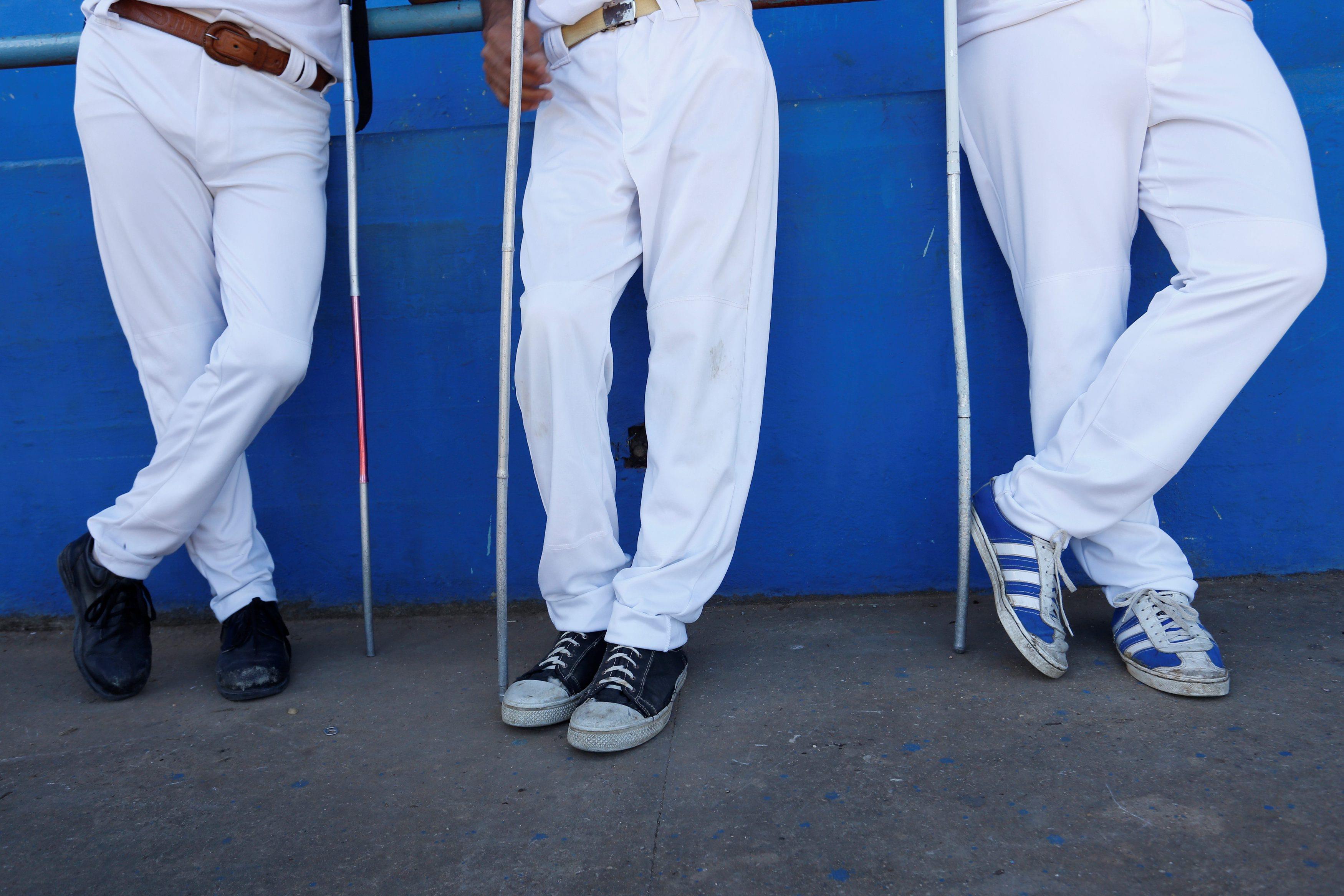The visually impaired wait for a baseball lesson to begin at the Changa Medero stadium, in Havana