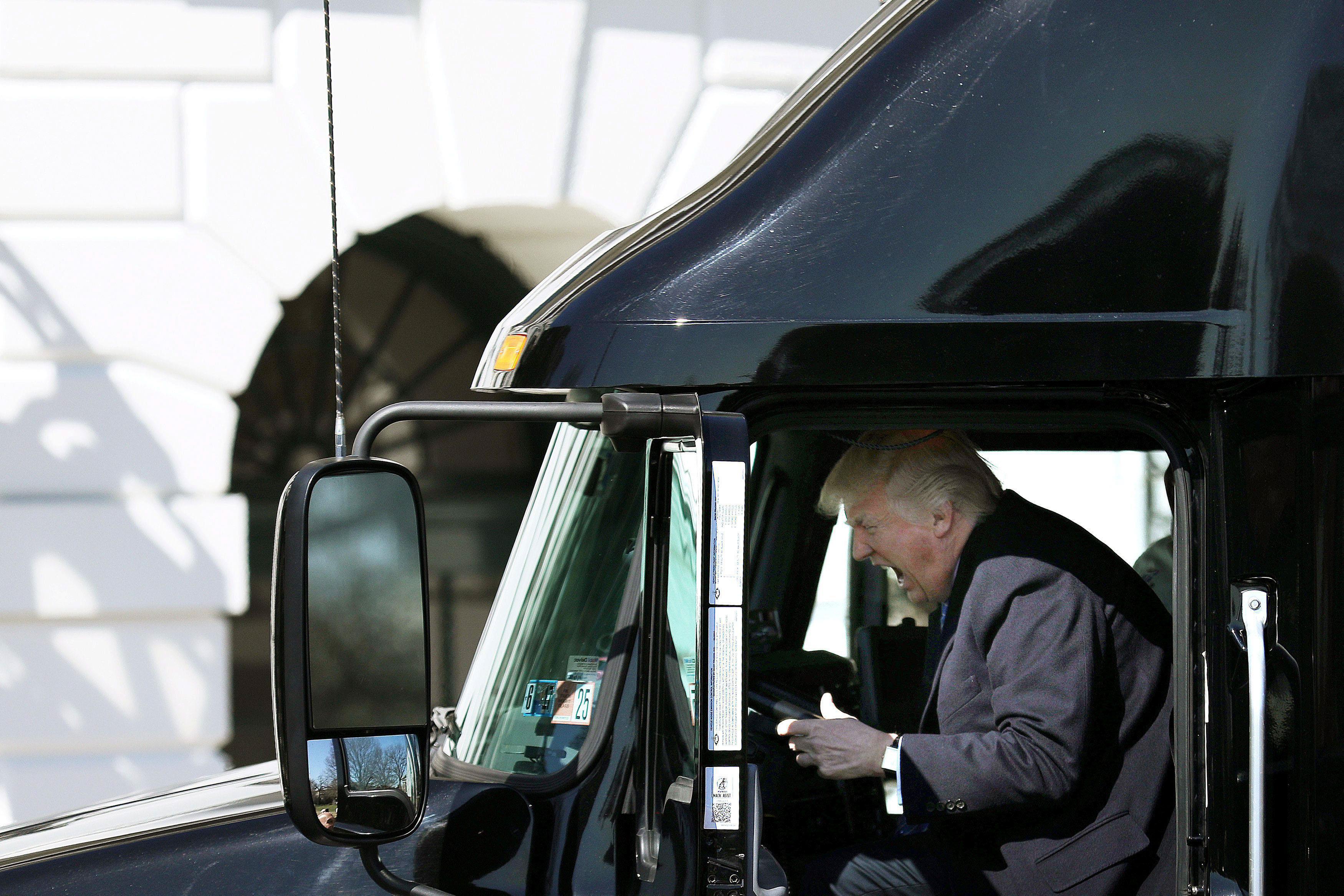 U.S. President Donald Trump reacts as he sits on a truck while he welcomes truckers and CEOs to atte