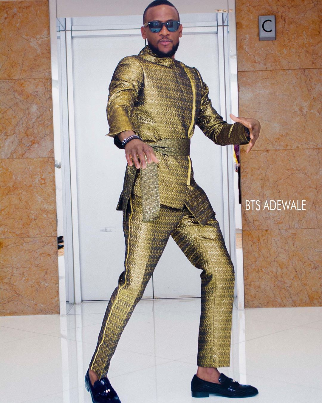 Omashola brought his A-game in a strapped suit [Credit: Omashola Kola Oburoh]