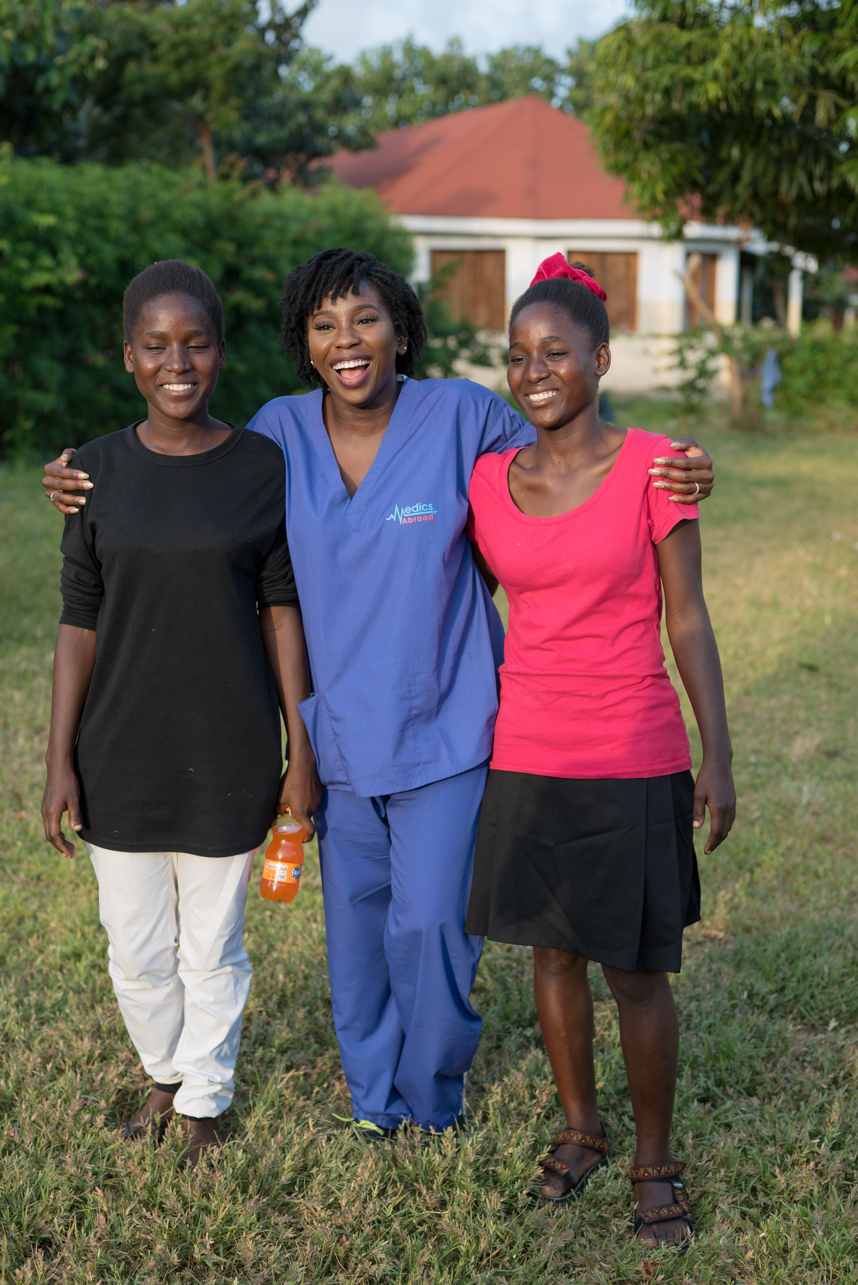 Dr Adanna with two young girls during a community engagement