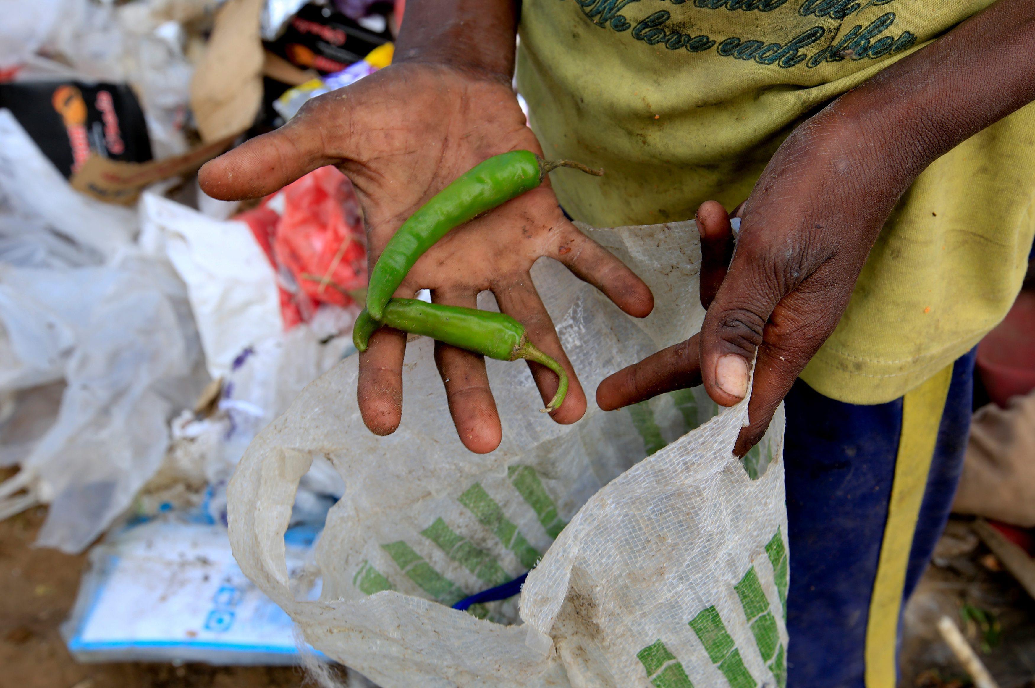 The Wider Image: Displaced Yemeni family sift through garbage for food