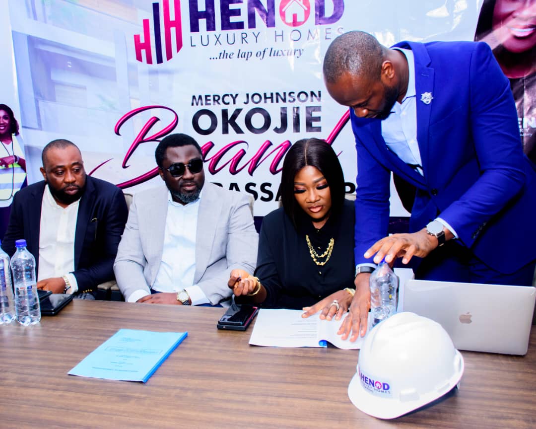 Mercy Johnson Okojie flanked by her husband and the a rep of the real estate firm