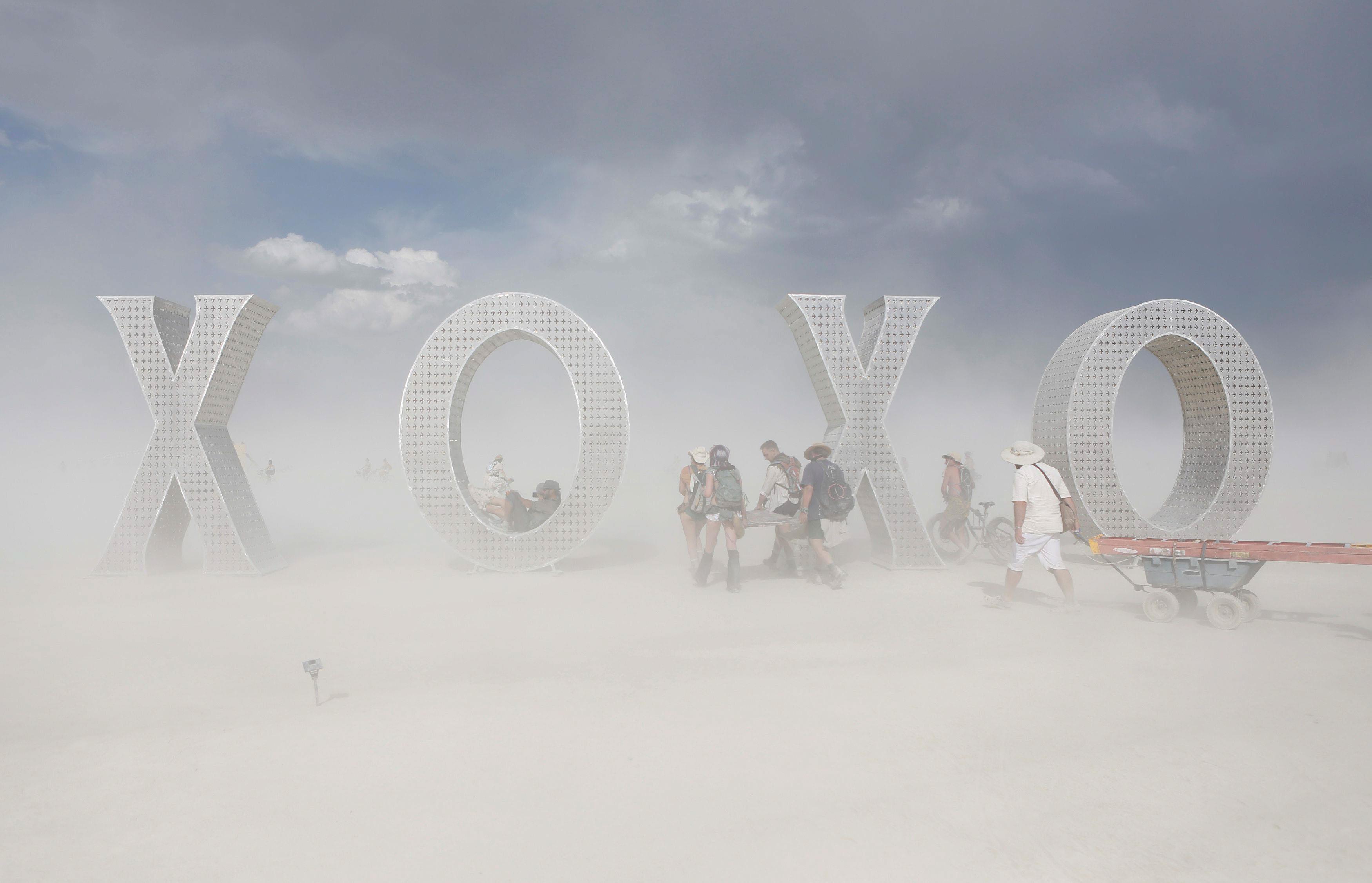 Participants make their way past an art installation as approximately 70,000 people from all over th