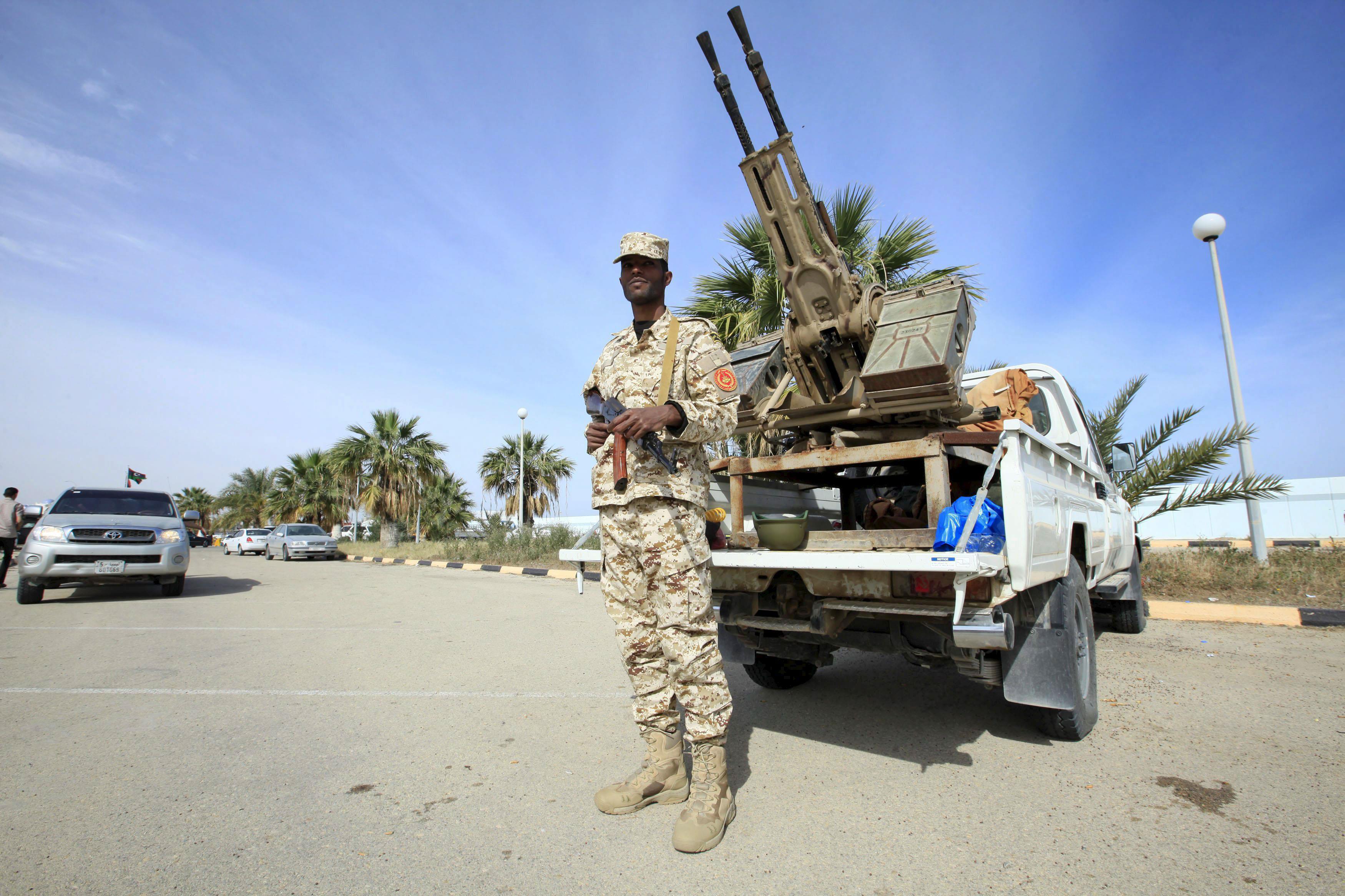 Member of the force assigned to protect Libya's unity government stands on a road leading to where t