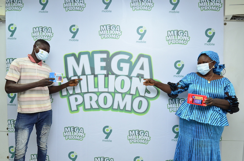 Yekini Jelili and Kanmi Tawa Adebukola after winning their smartphone in the ongoing 9mobile Mega Millions Promo prize presentation held in Lagos recently