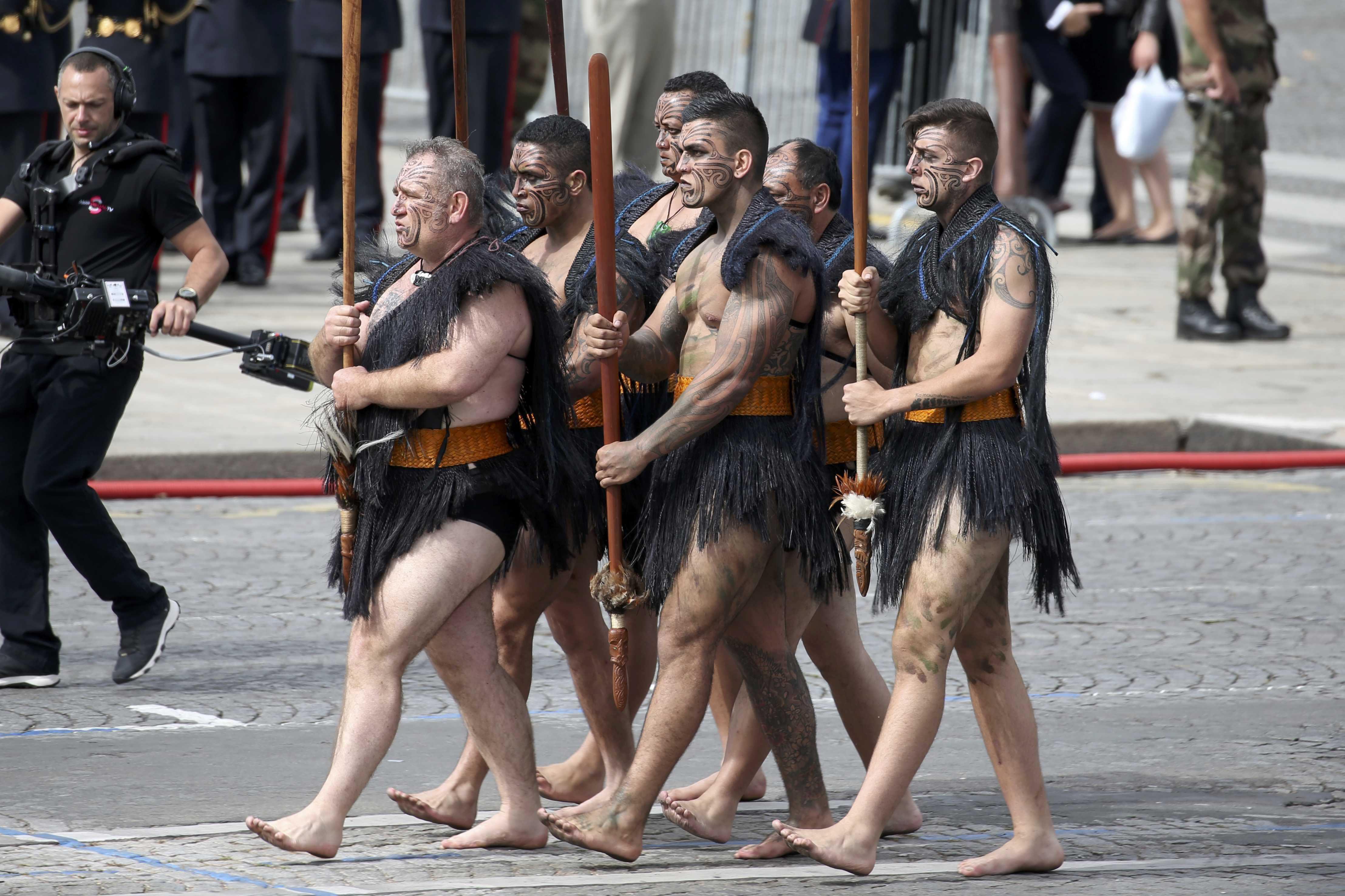 Maori warriors from New Zealand march during the traditional Bastille Day military parade on the Pla