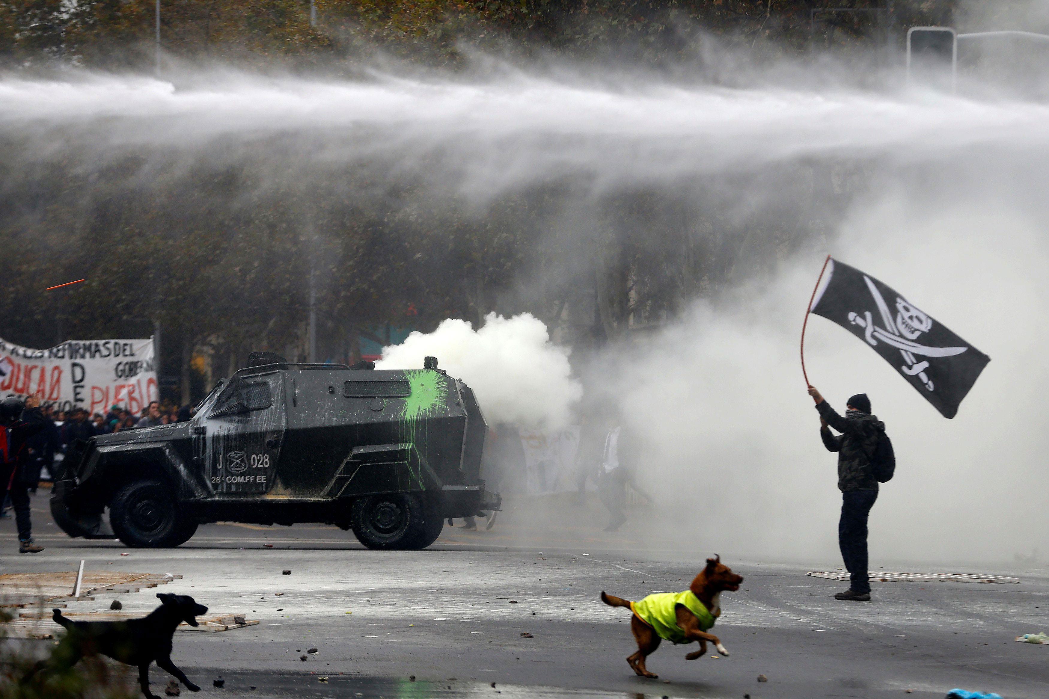 A student clashes with riot police during a demonstration to demand changes in the education system 