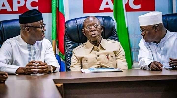Embattled National Chairman of the riling APC, Adams Oshiomhole, flanked by party men. (Legit) 
