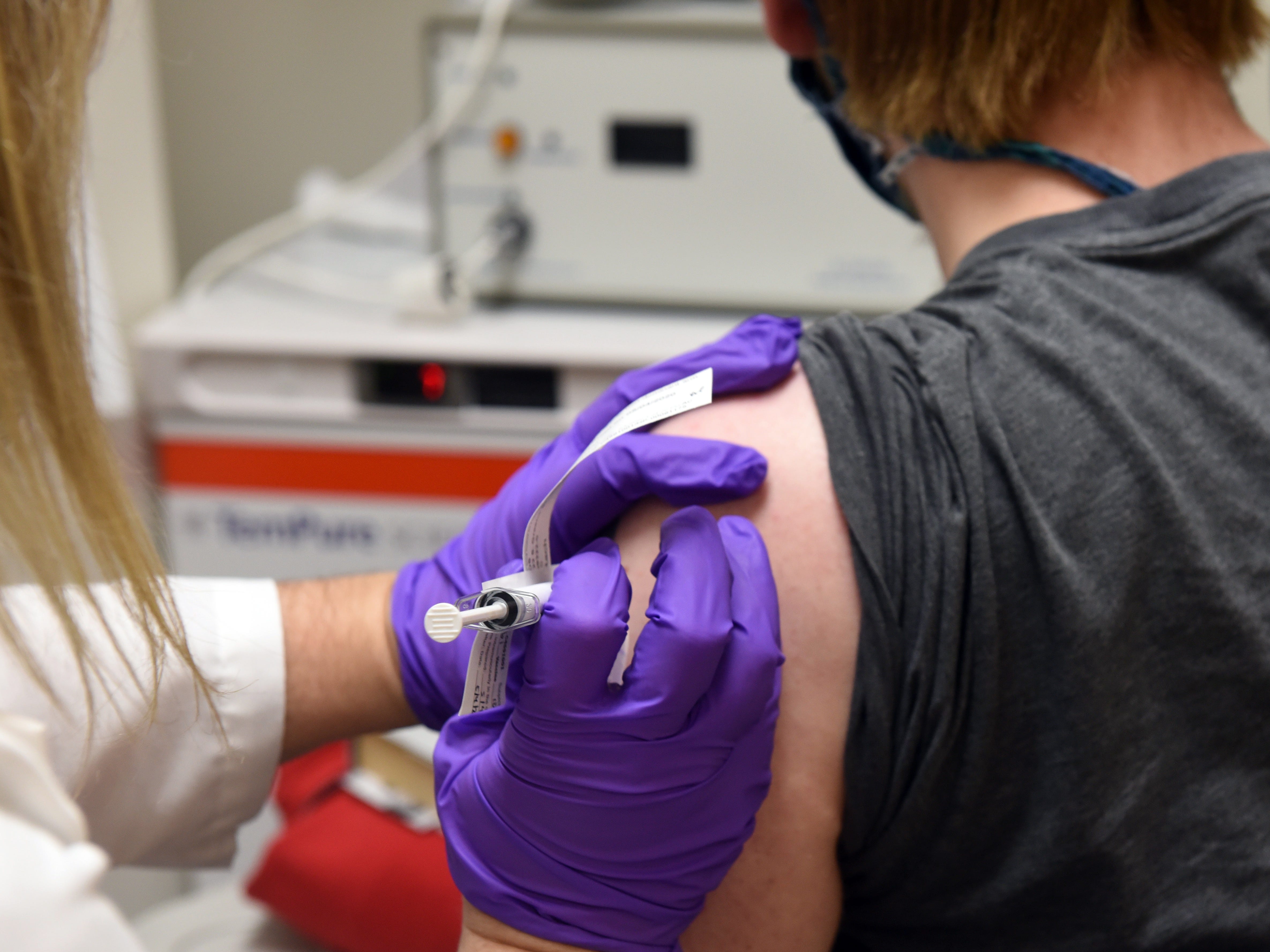 A volunteer gets a shot of Pfizer's COVID-19 vaccine (BusinessInsider) 