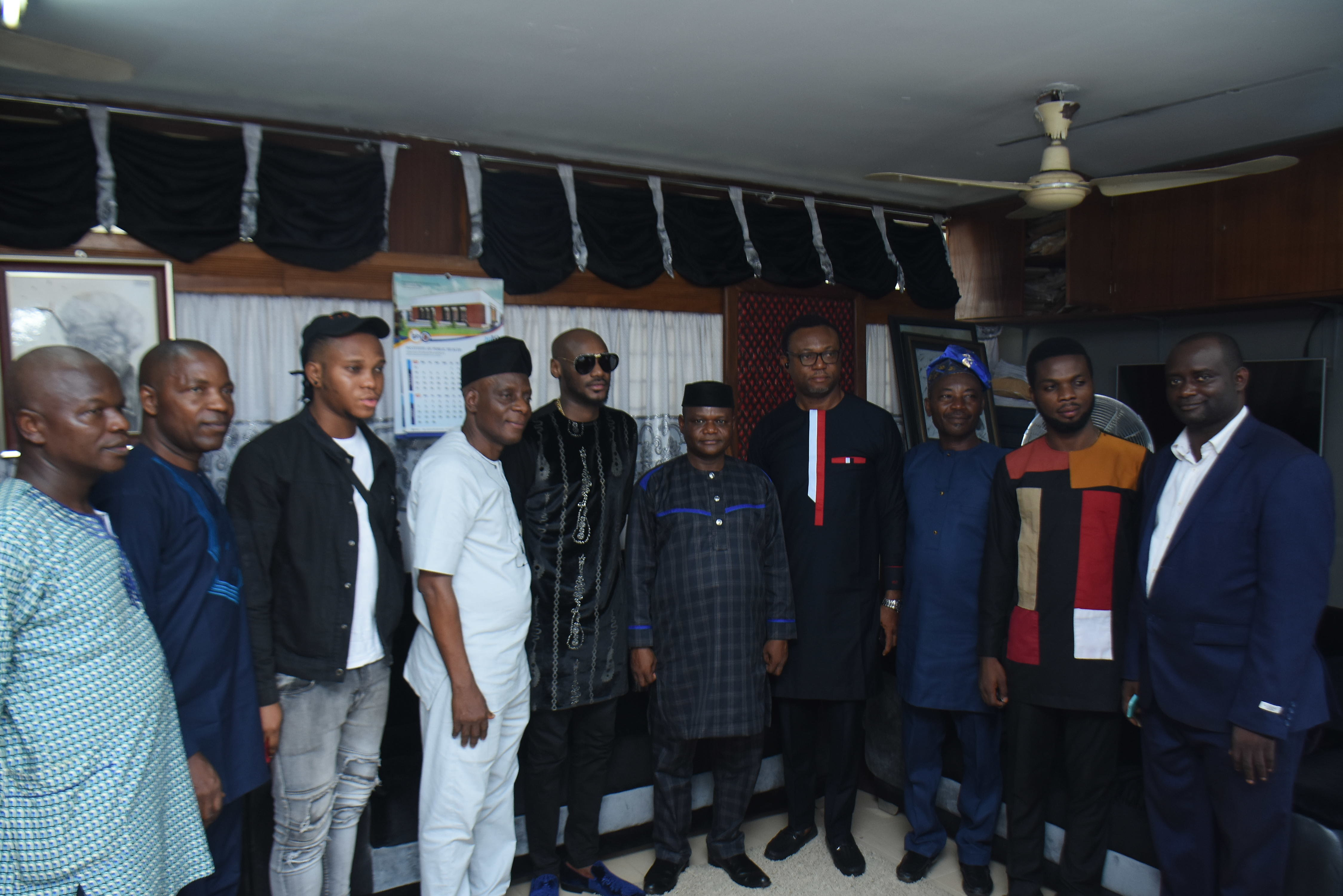 2Face Idibia flanked by staff of the Obafemi Awolowo University, Ile Ife