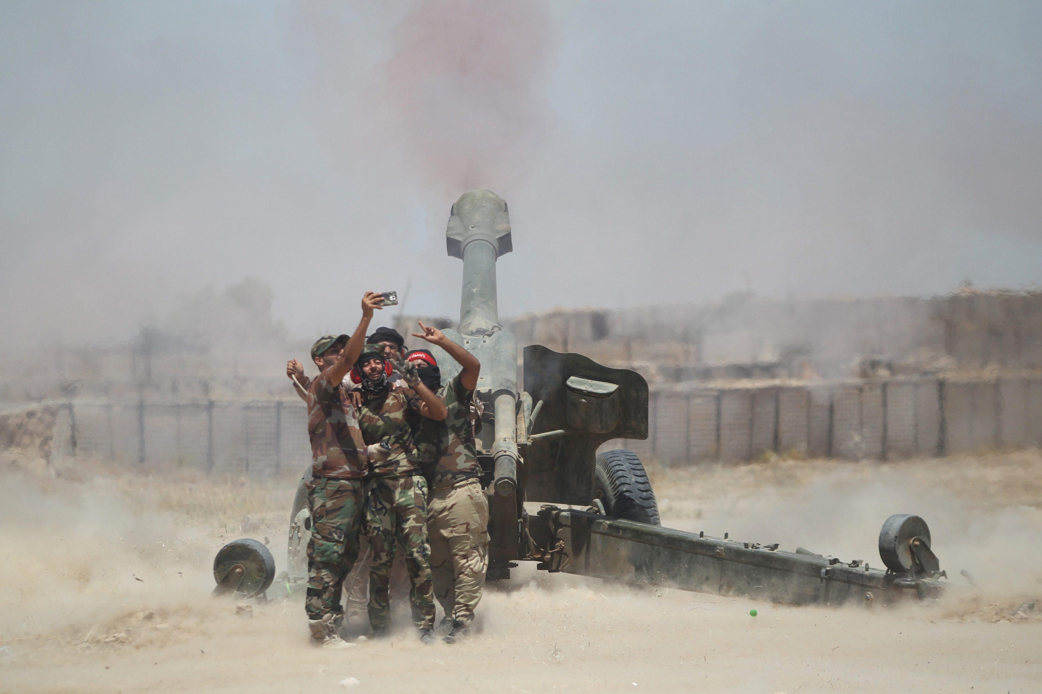 Shi'ite fighters take a selfie while firing artillery towards Islamic State militants near Falluja
