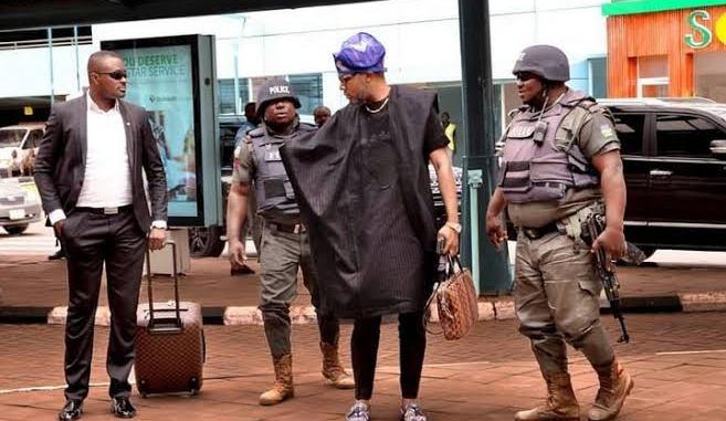 A Nigerian entertainer, E-money  and hos police orderlies (Green-White-Green)