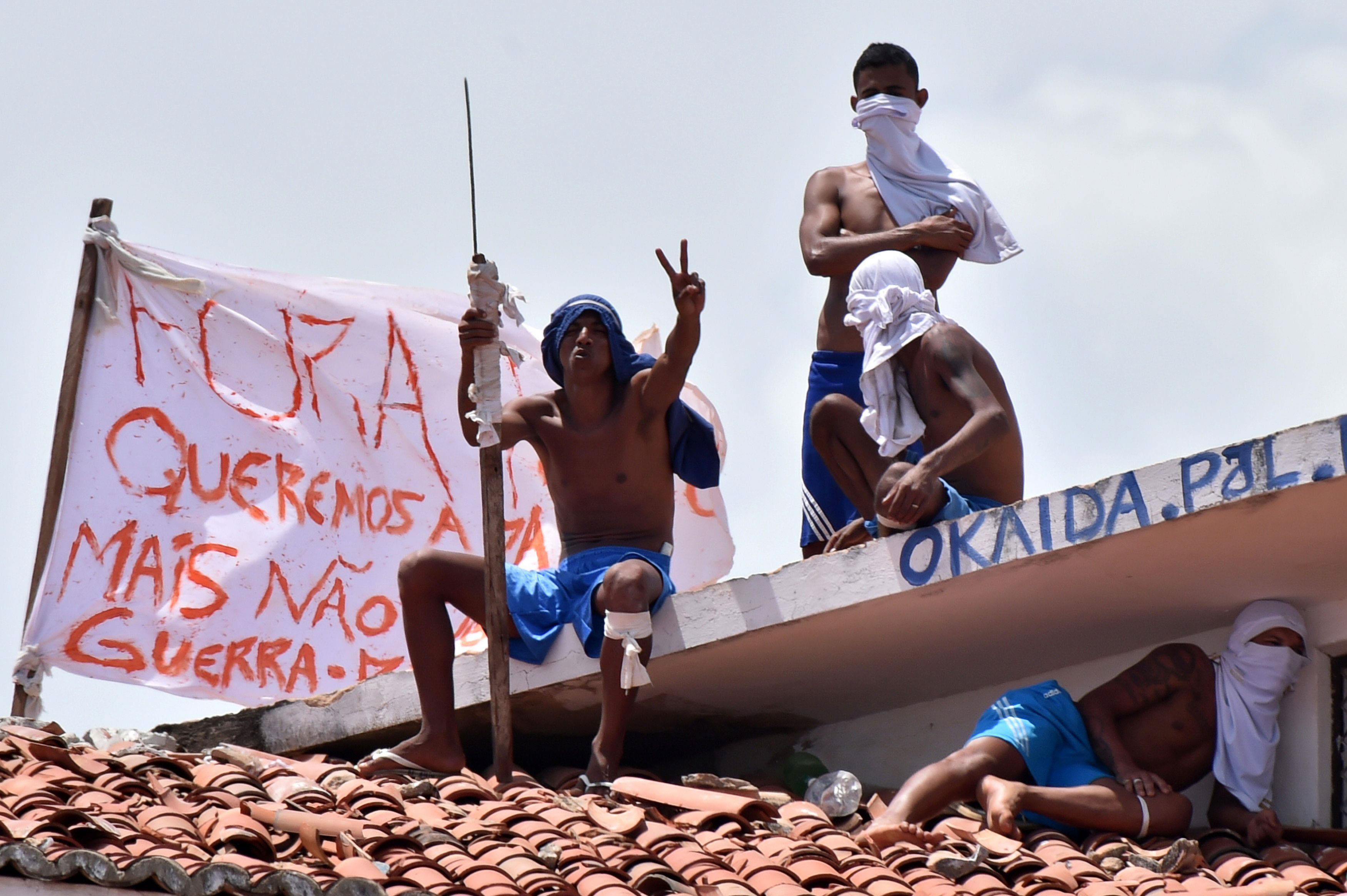 Inmates are seen on a roof during an uprising at Alcacuz prison in Natal