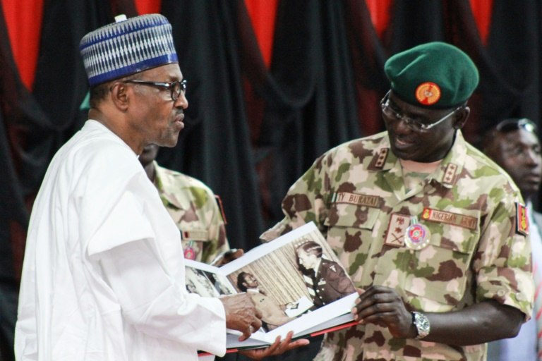 Nigeria's President Muhammadu Buhari, seen here with the army chief of staff this week, is under pressure to show results in the fight against Boko Haram ahead of February elections