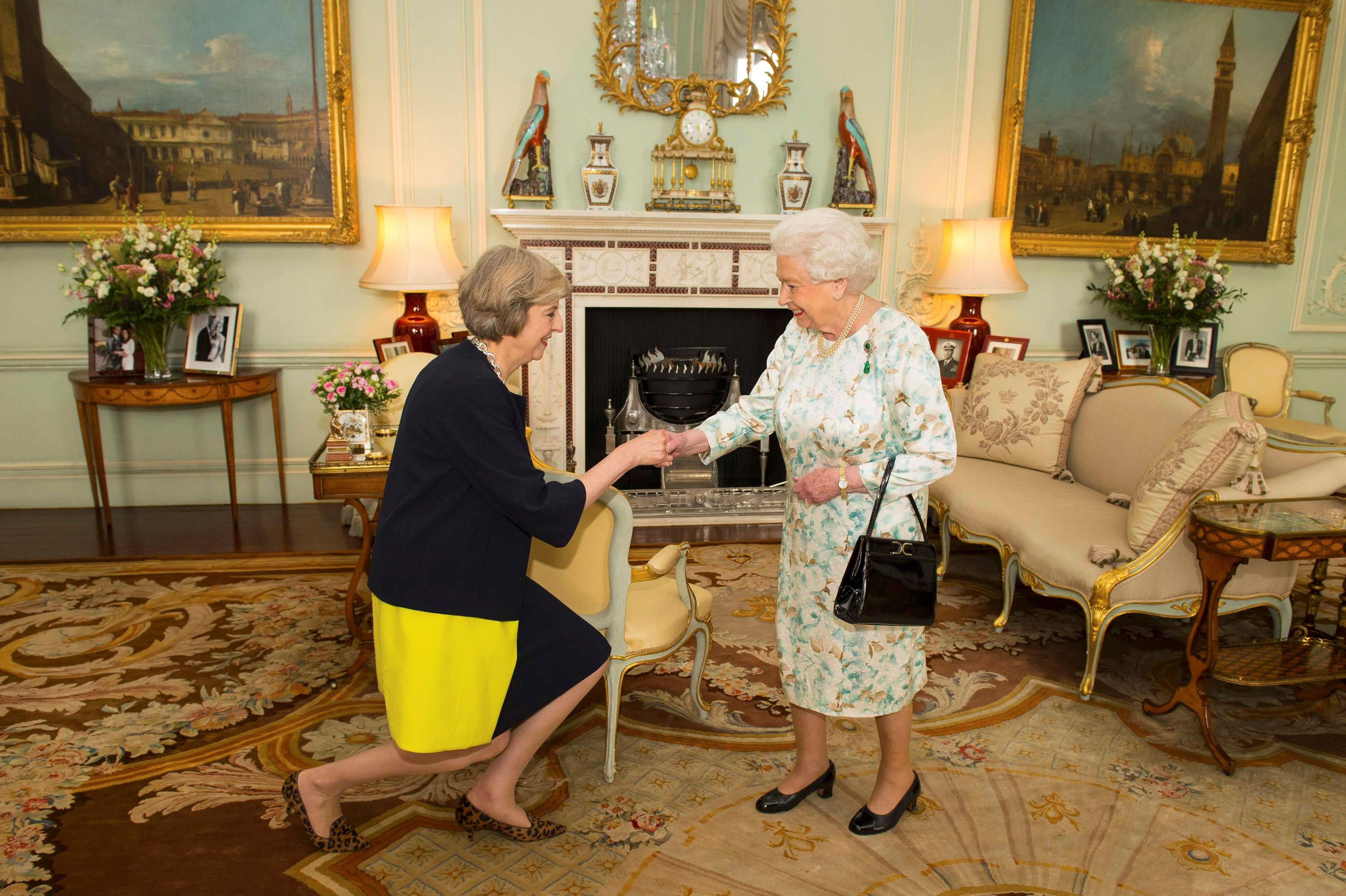 Britain's Queen Elizabeth welcomes Theresa May at the start of an audience in Buckingham Palace, whe