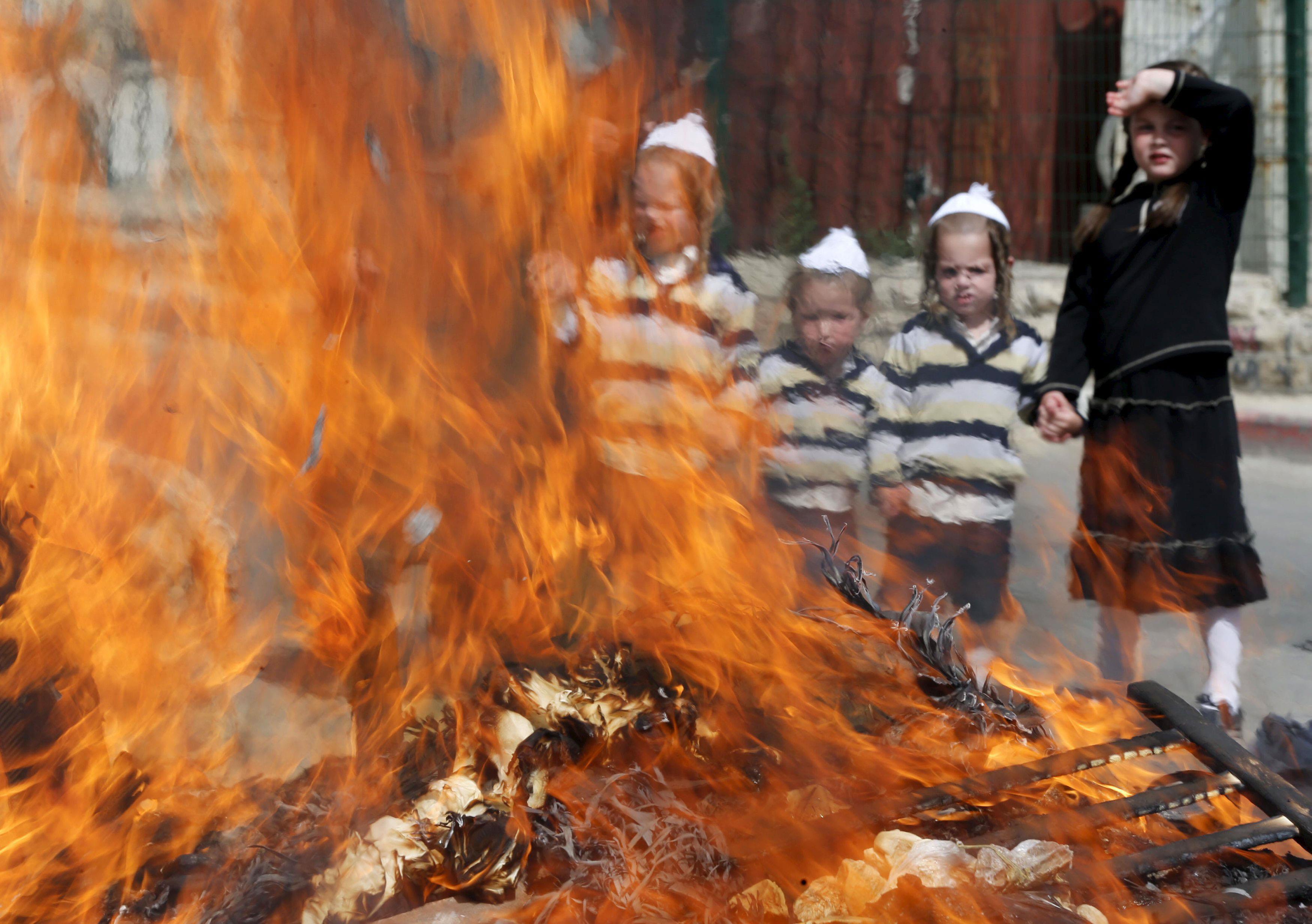 Ultra-Orthodox Jewish boys burn leaven in the Mea Shearim neighbourhood of Jerusalem ahead of the Je