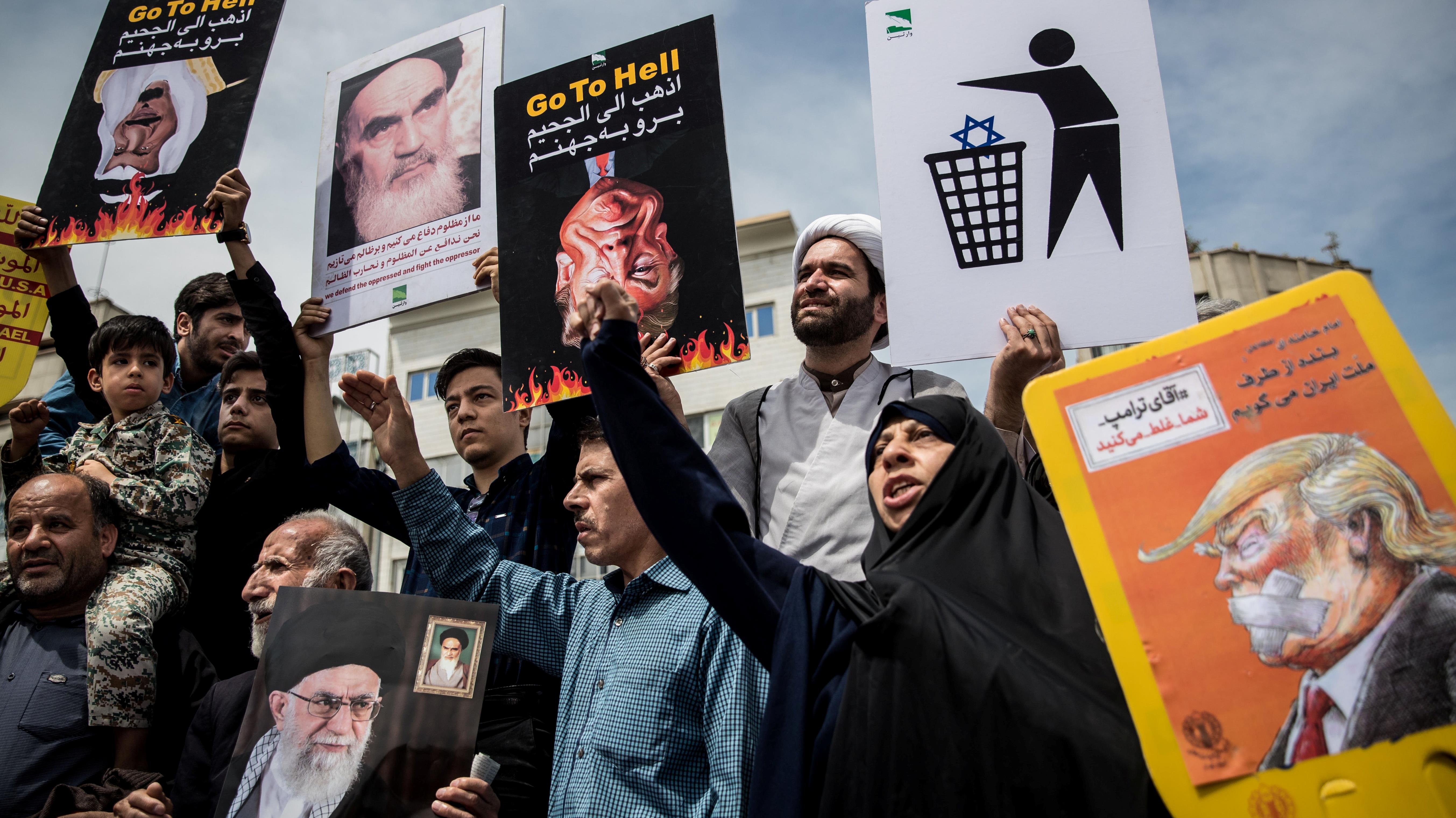 Iranians shout slogans during a protest against President Donald Trump's decision to walk out of a 2