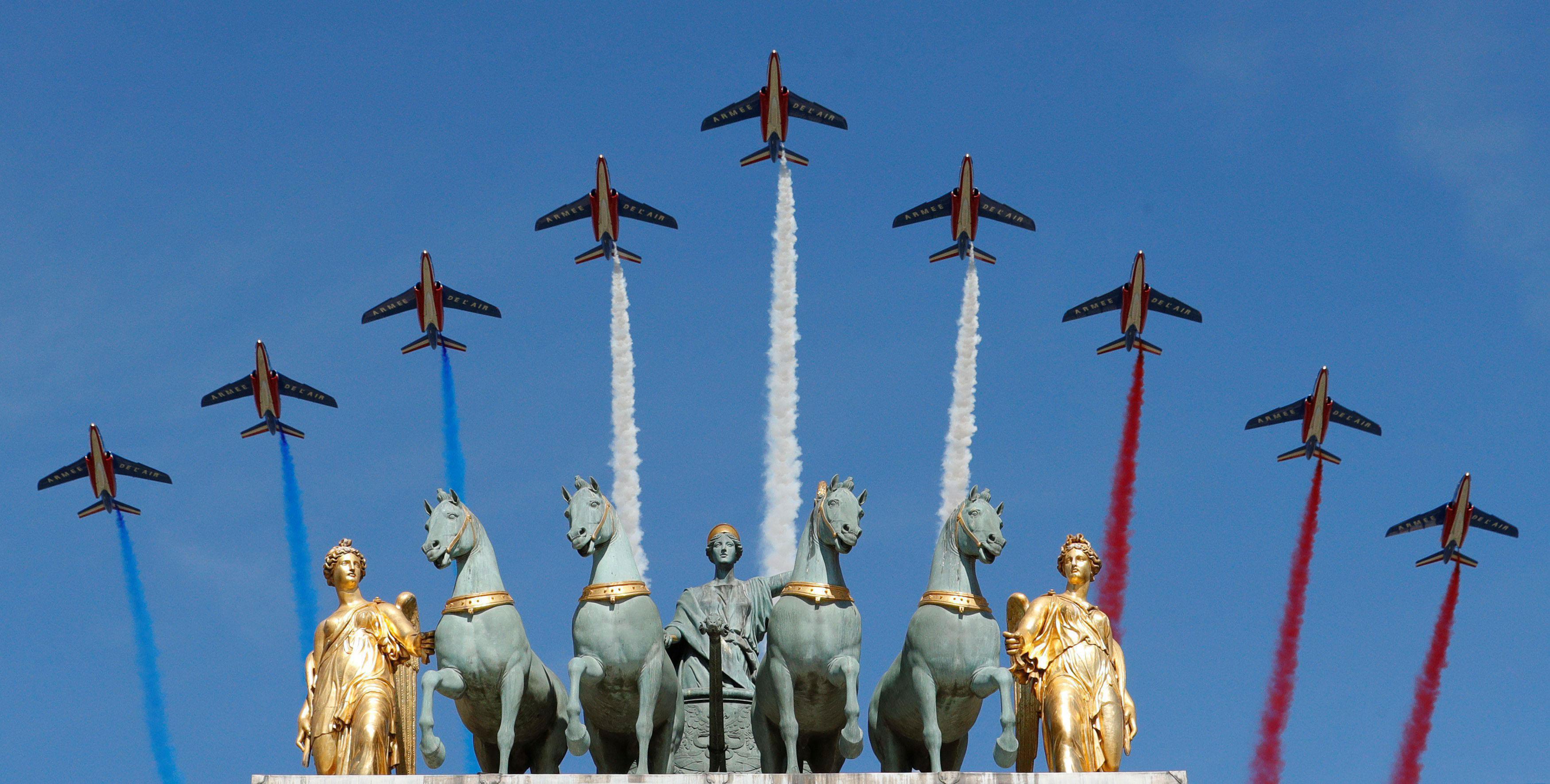 Alpha jets from the French Air Force Patrouille de France fly over the Arc de Triomphe du Carrousel 