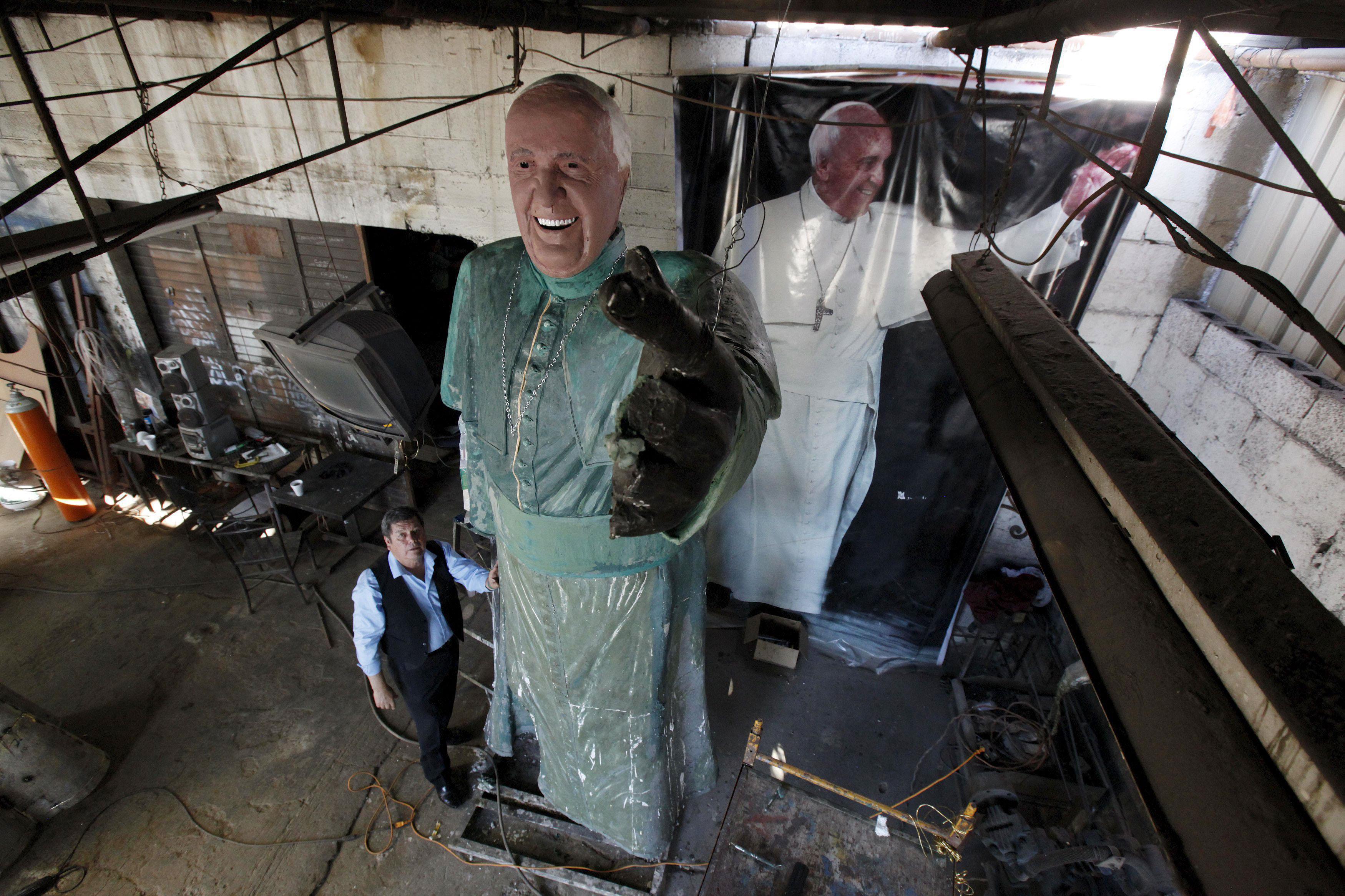 Sculptor Rodriguez poses with his bronze statue of Pope Francis at his workshop in Ciudad Juarez