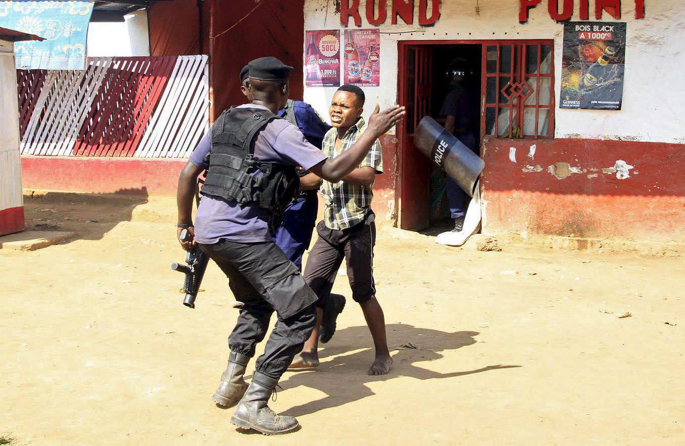 Policemen detain a protester during clashes in Lubumbashi, Democratic Republic of Congo