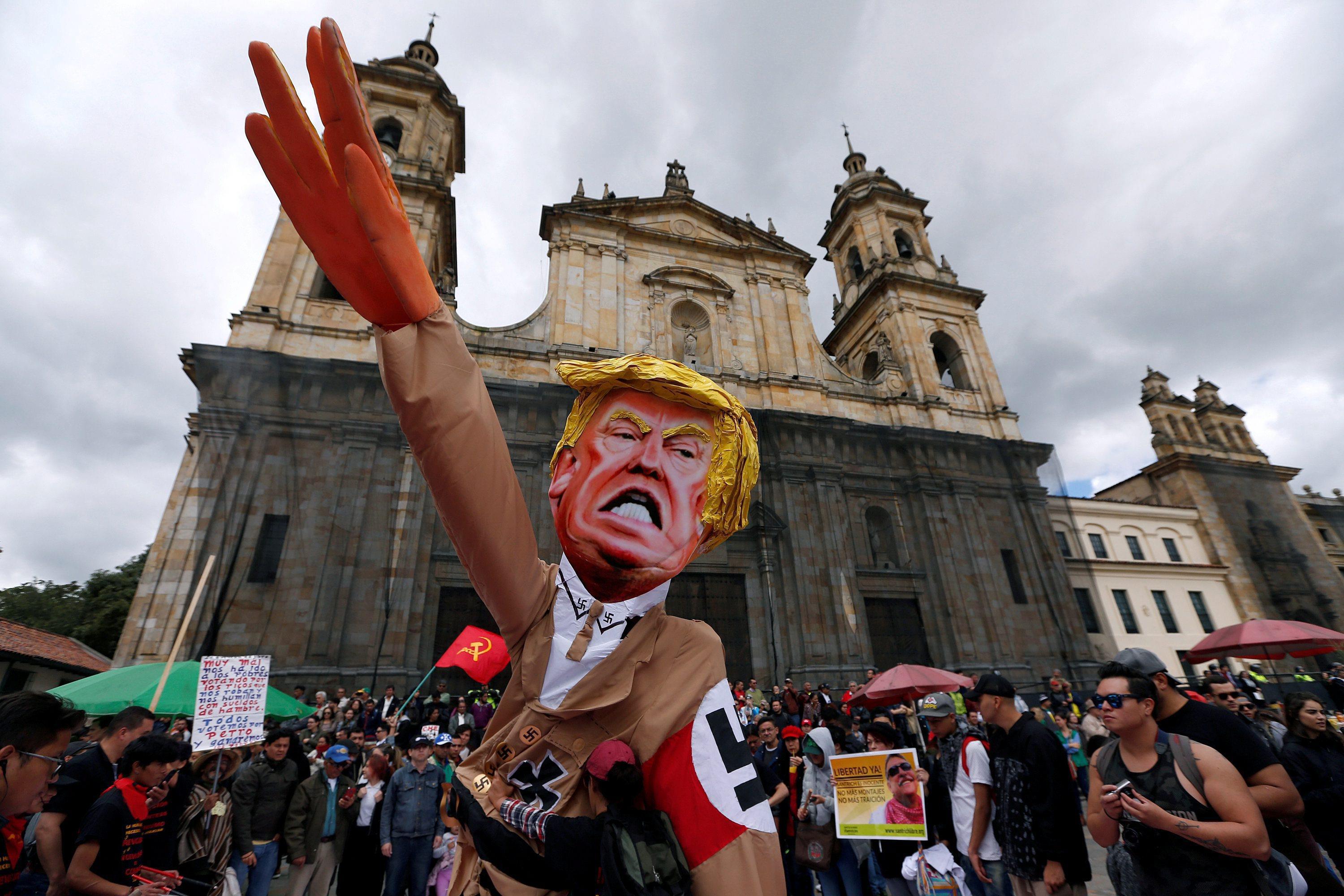 Protesters carry cutout depicting Trump in Nazi uniform during May Day rally in Bogota