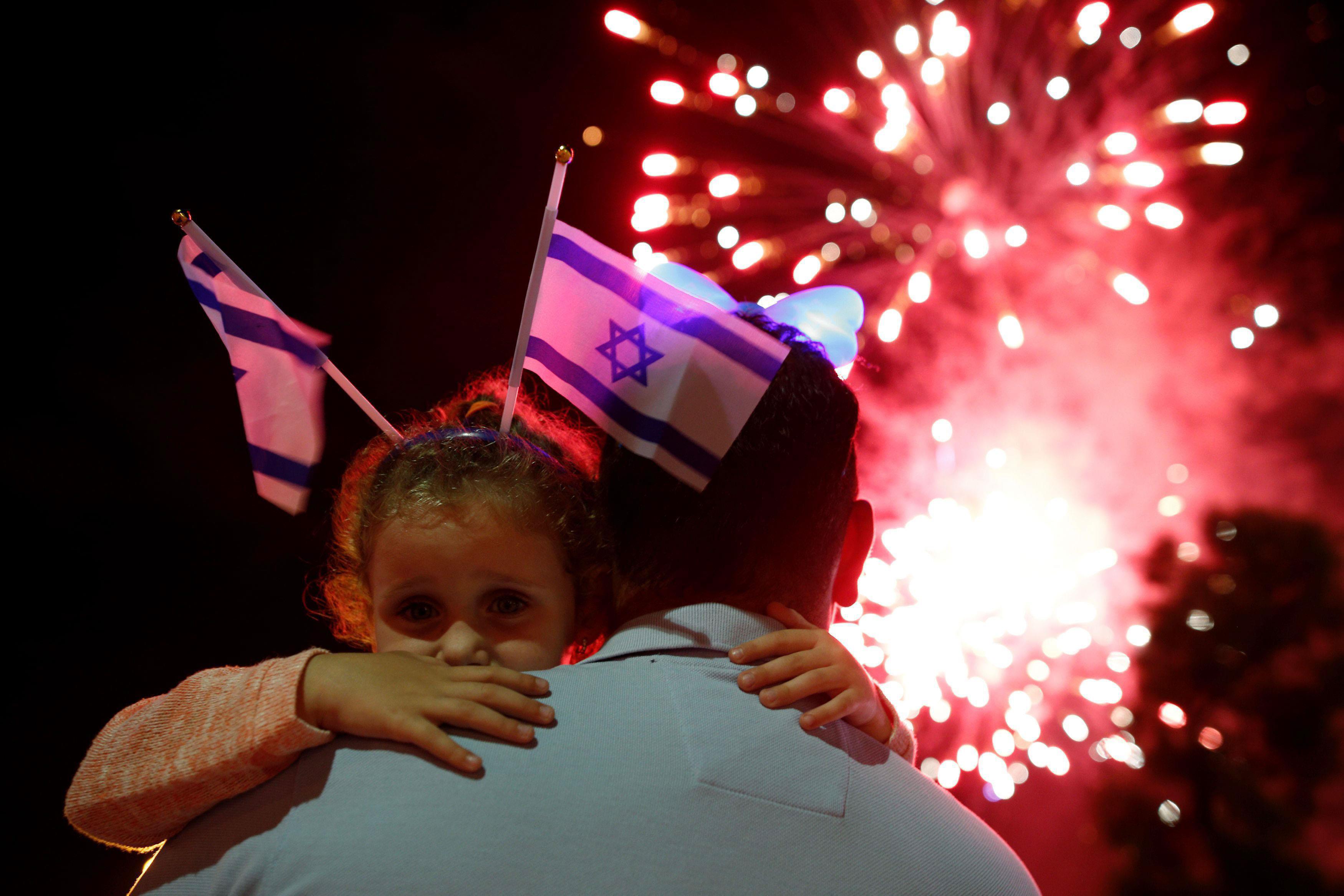 Israelis watch a fireworks show during celebrations marking Israel's 68th Independence Day in the so