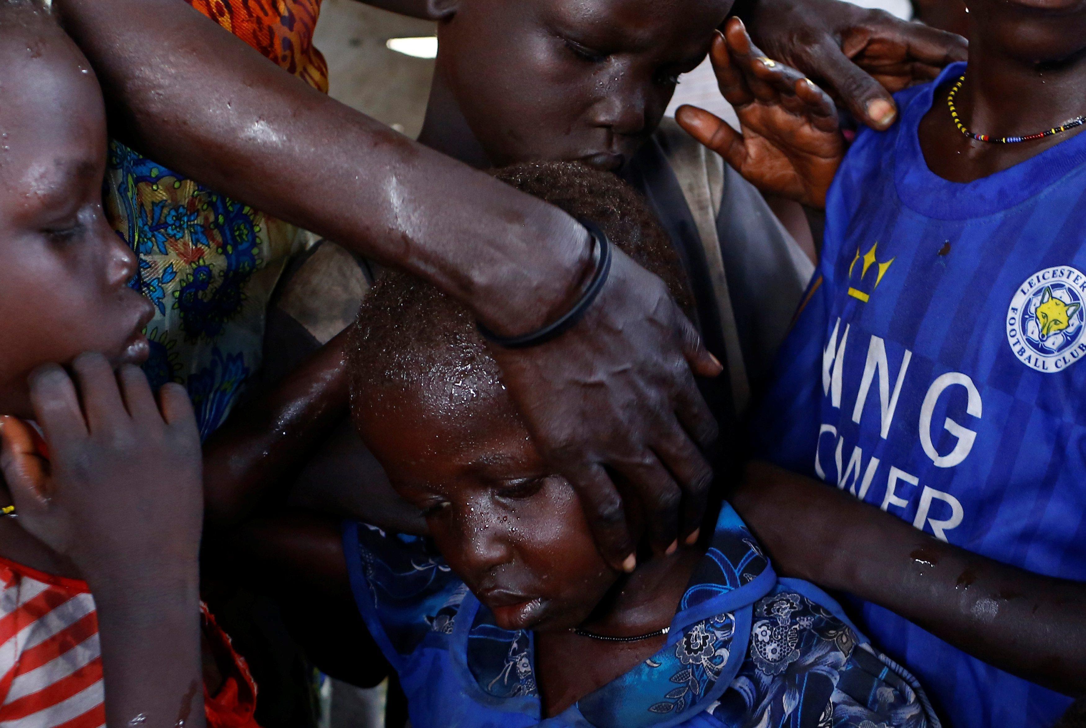 The Wider Image: Mother reunited with children after five-year search