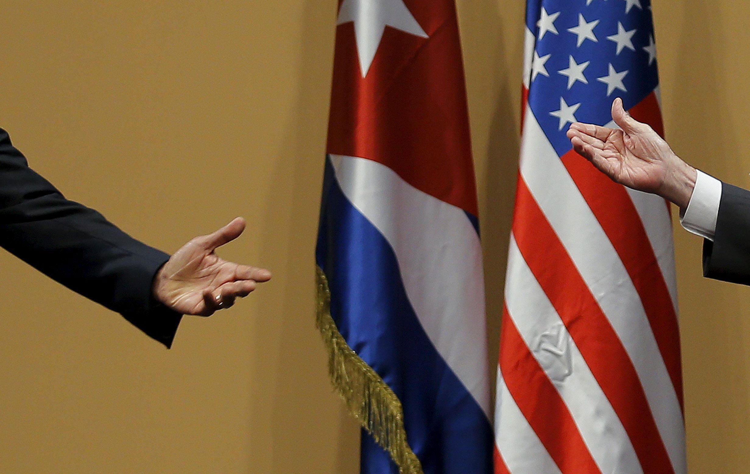 The hands of U.S. President Barack Obama and Cuban President Raul Castro are seen during a news conf
