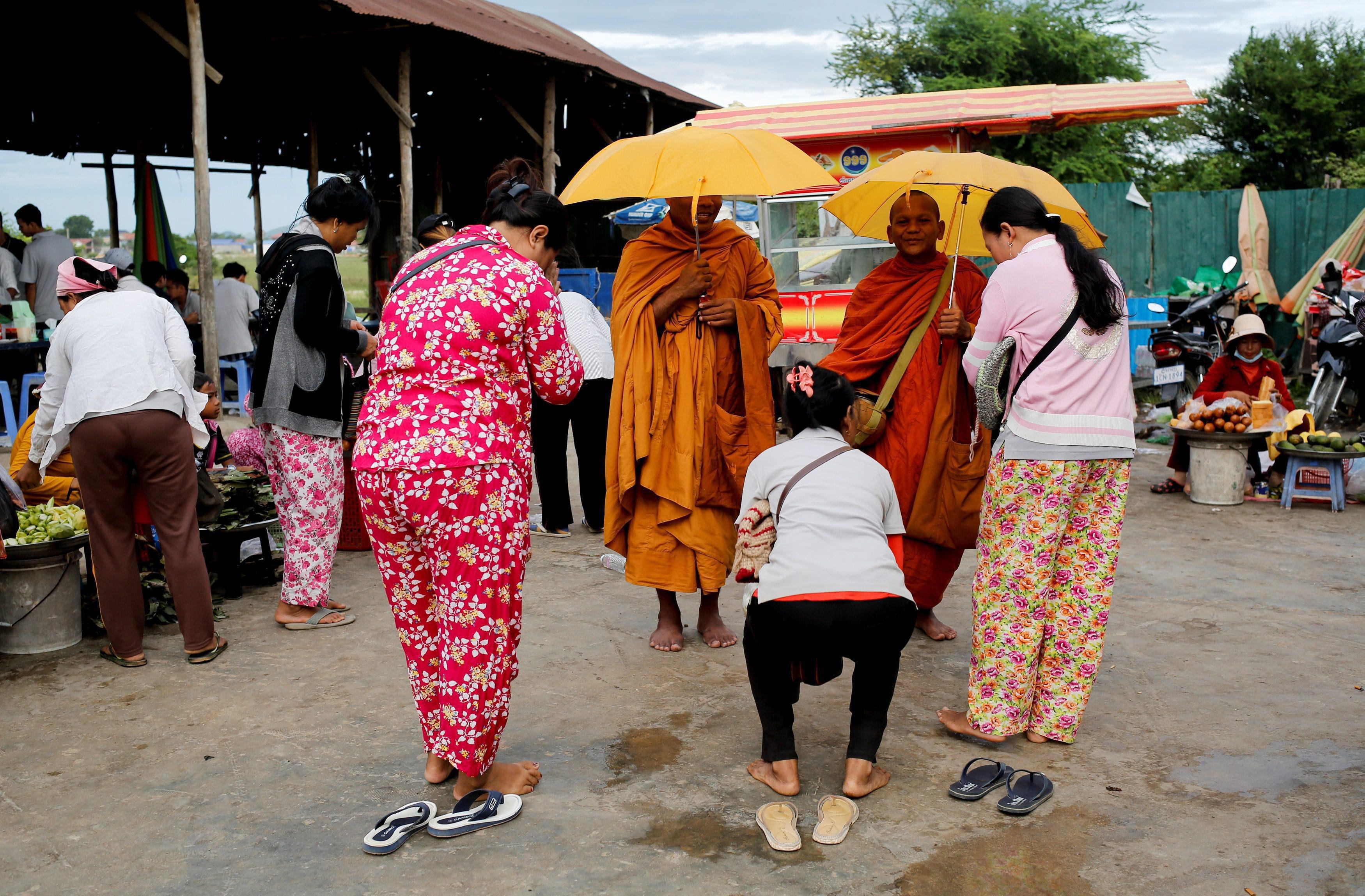 The Wider Image: Cambodian shoe maker has little time for politics