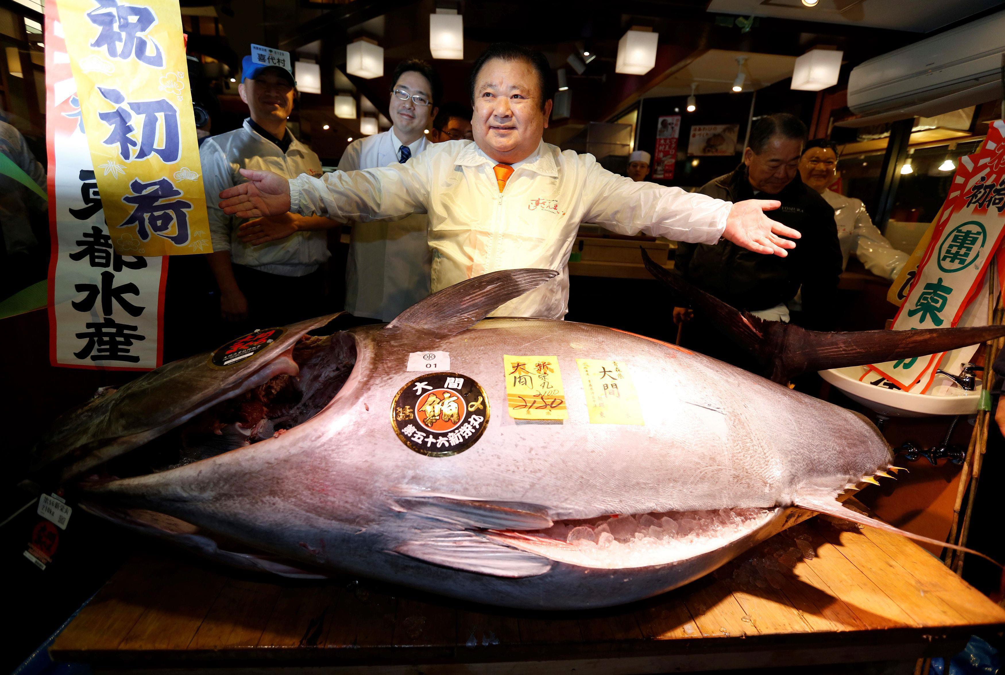 Kiyomura Co's President Kiyoshi Kimura, who runs a chain of sushi restaurants Sushi Zanmai, poses wi