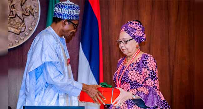 President Muhammdu Buhari receiving the report of the Tripartite Committee on the Review of National Minimum Wage from the Committee Chairman, Mrs Amal Pepple, at the State House on November 6, 2018.