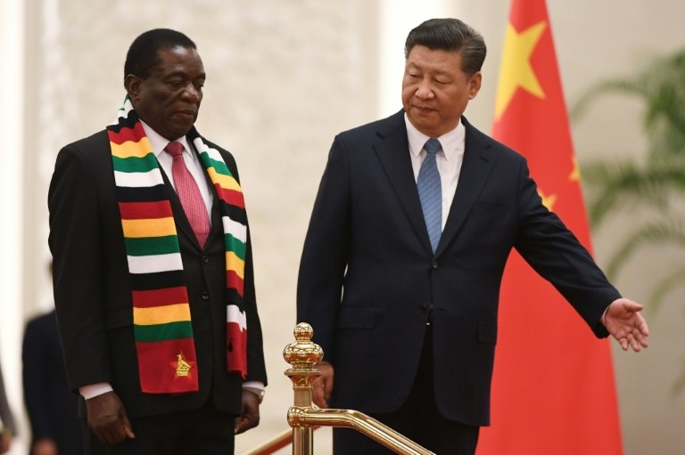 Zimbabwe's President Emmerson Mnangagwa (L) stands with Chinese President Xi Jinping during a welcoming ceremony at the Great Hall of the People in Beijing on April 3, 2018