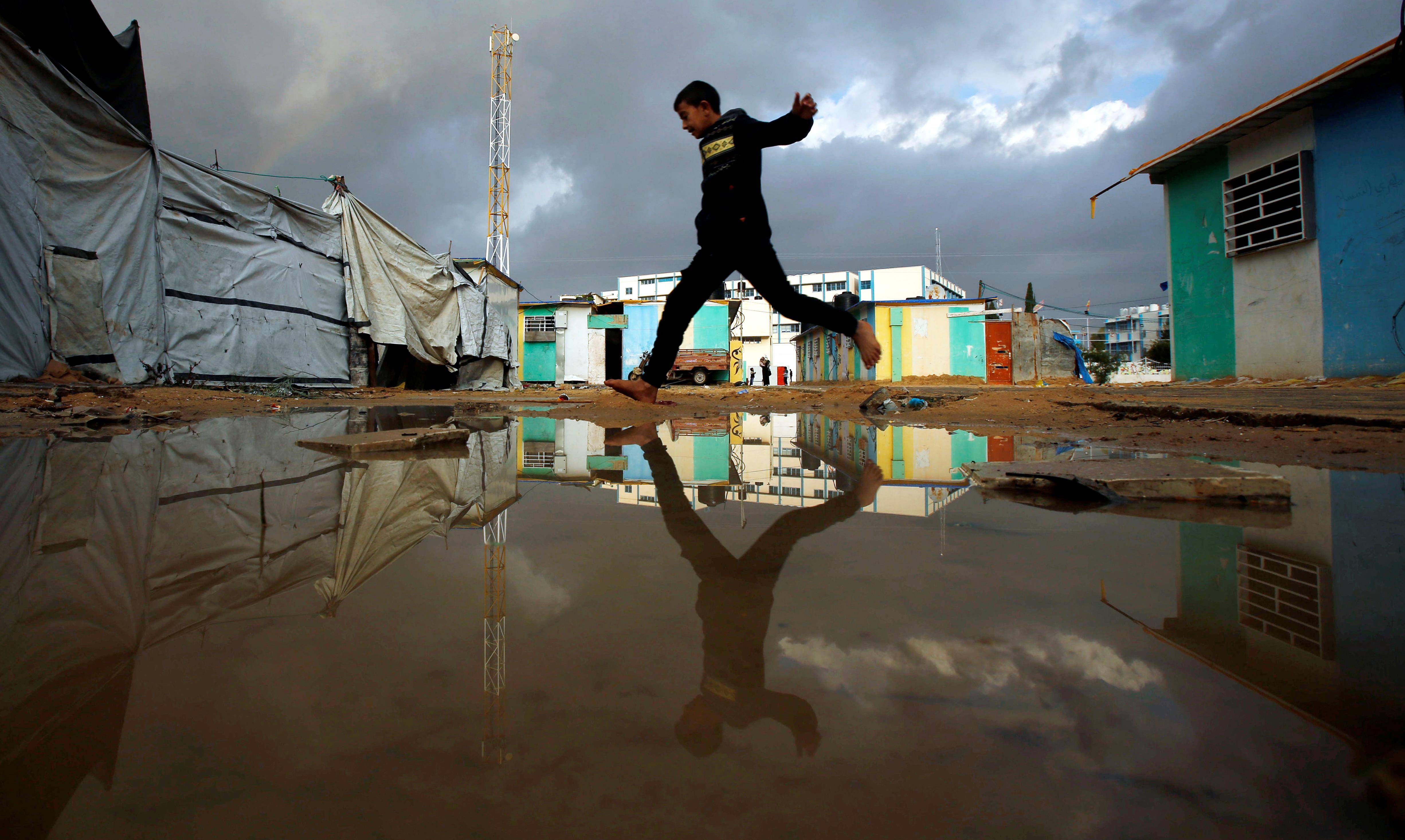 A Palestinian boy who lives in a container as a temporary replacement for his house that was destroy