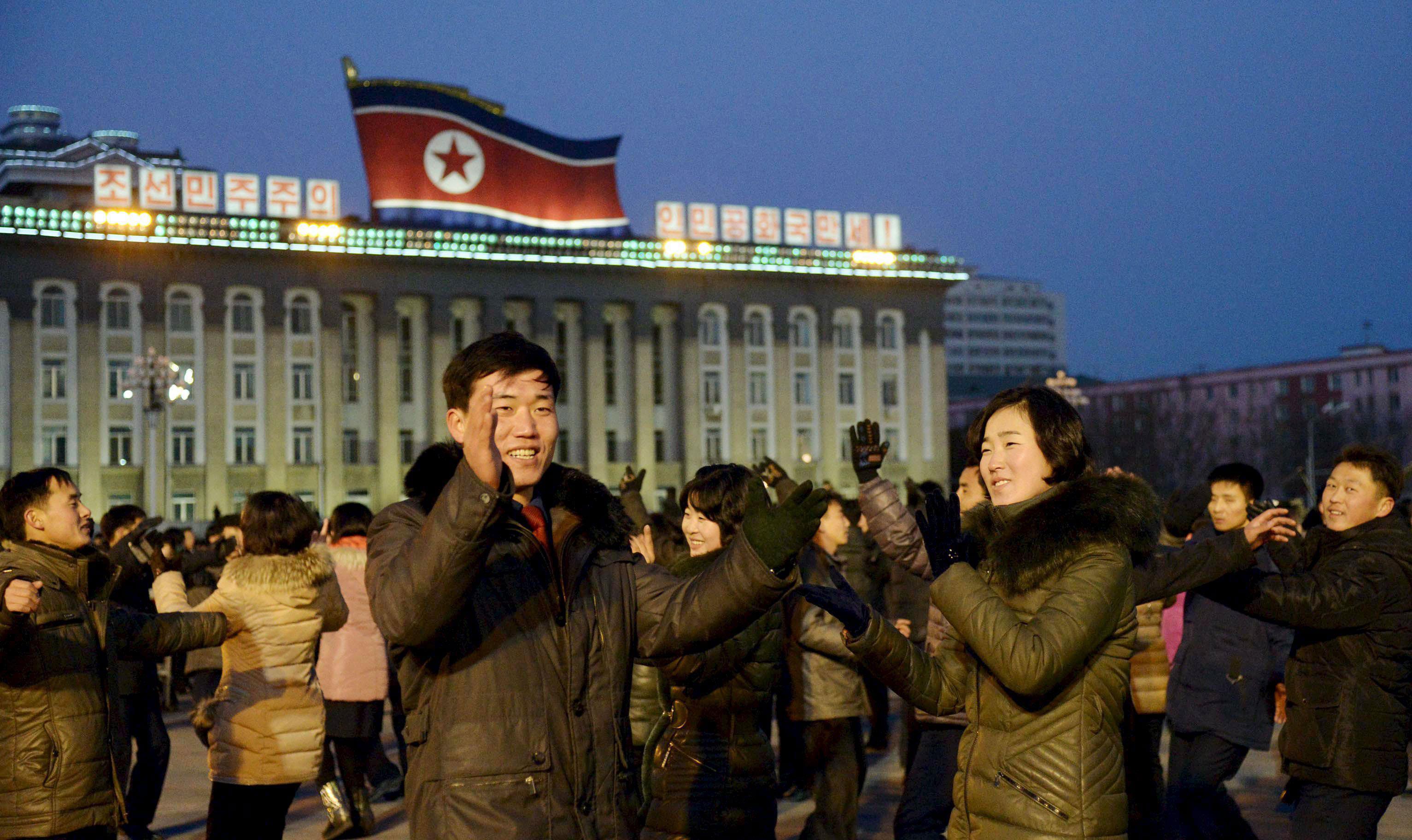 North Koreans dance to celebrate what the country claims was a 