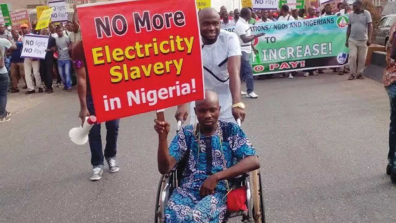 A physically challenged customer leads NLC protest over increase  in electricity tariff in Benin). 