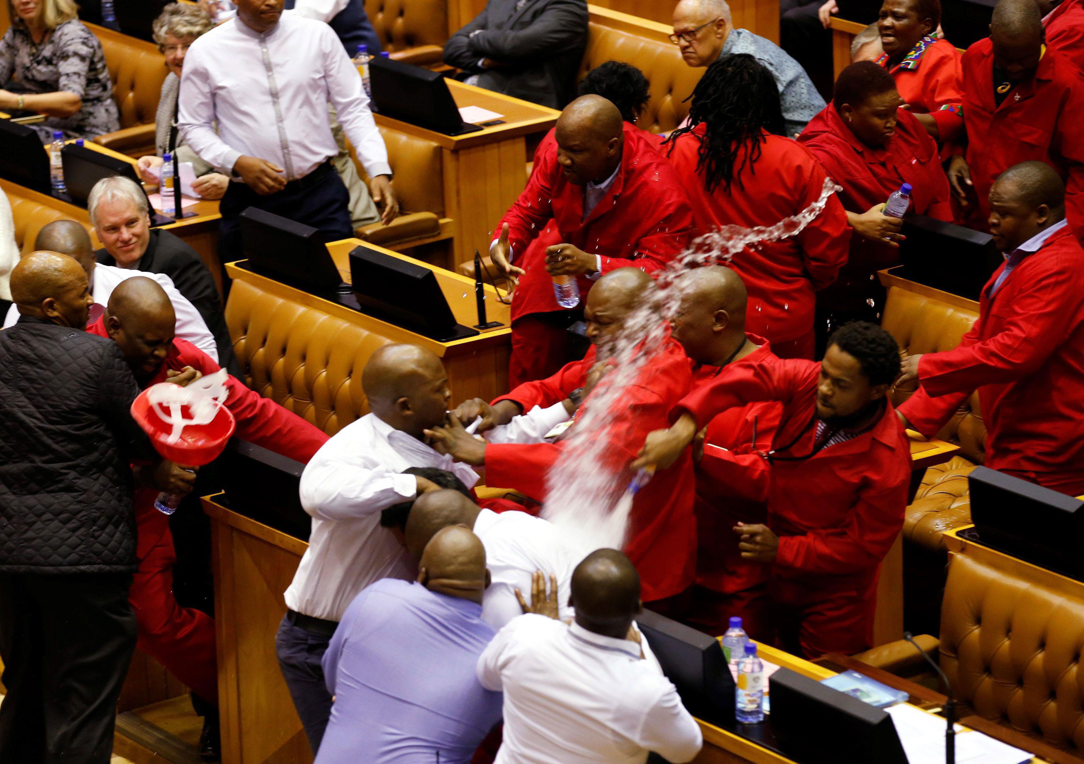 Party leader Julius Malema and members of his Economic Freedom Fighters (EFF) clash with Parliamenta