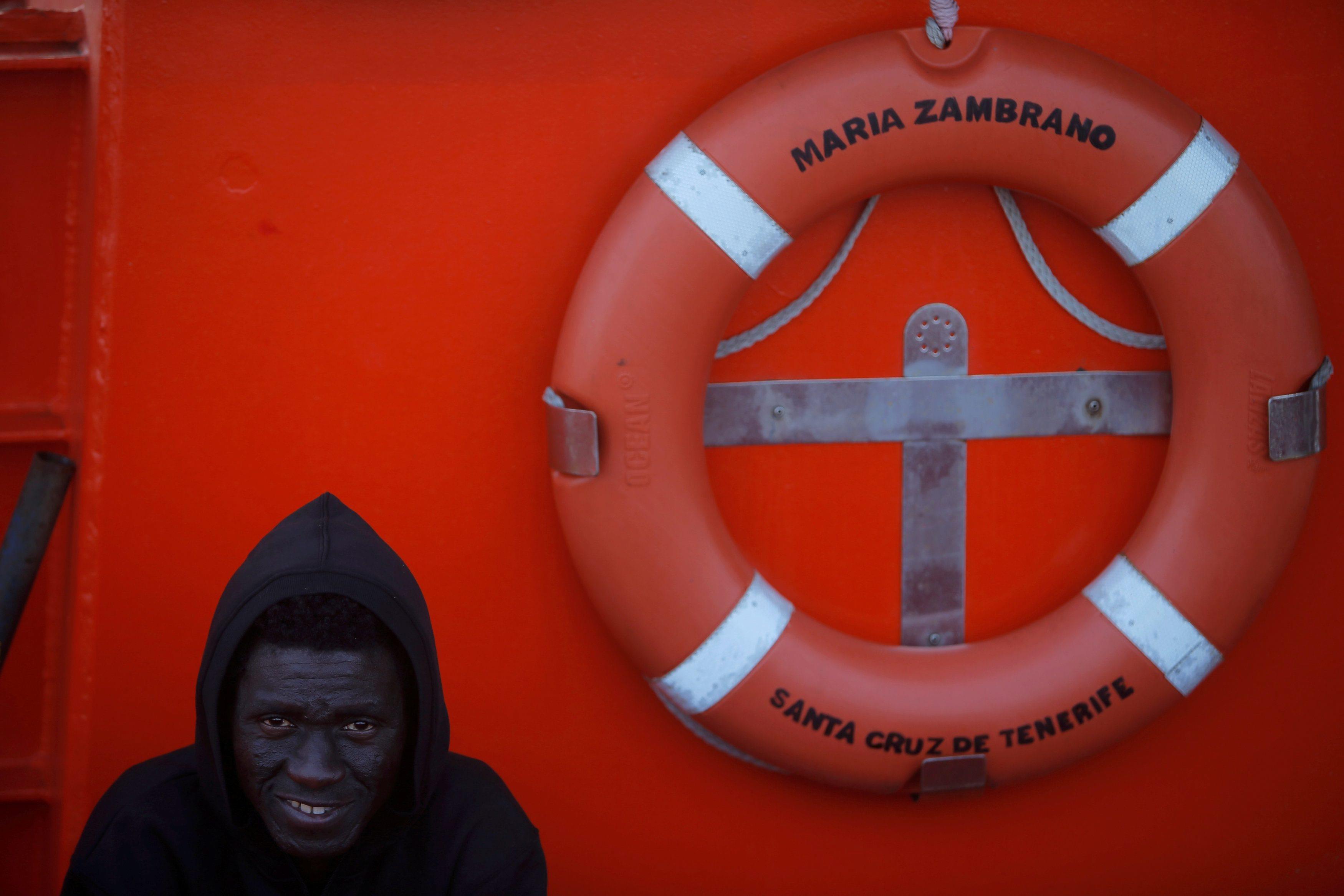 A migrant waits on a rescue boat to disembark after arriving at the port of Algeciras