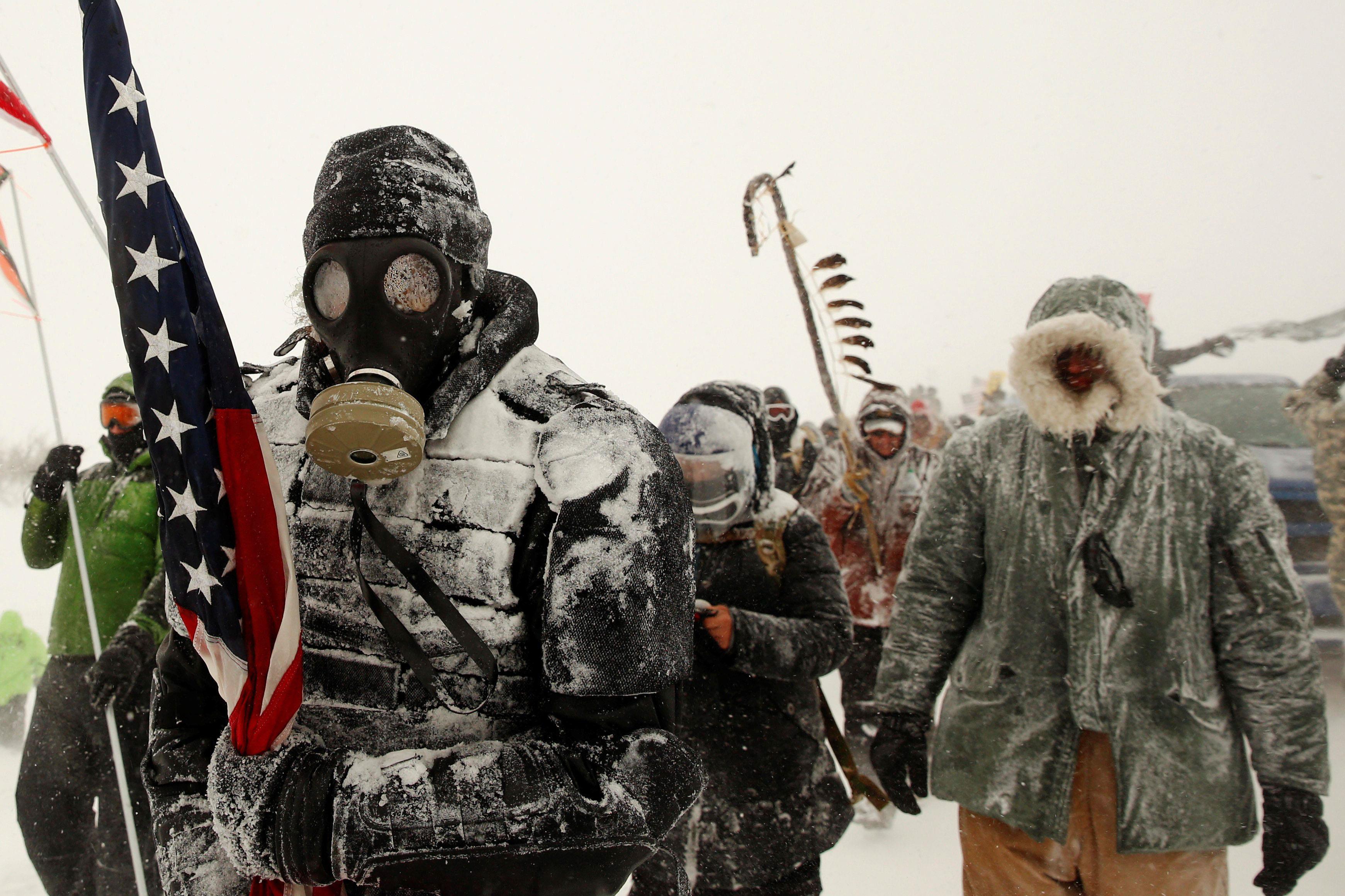 A man takes part in a march with veterans to Backwater Bridge just outside of the Oceti Sakowin camp