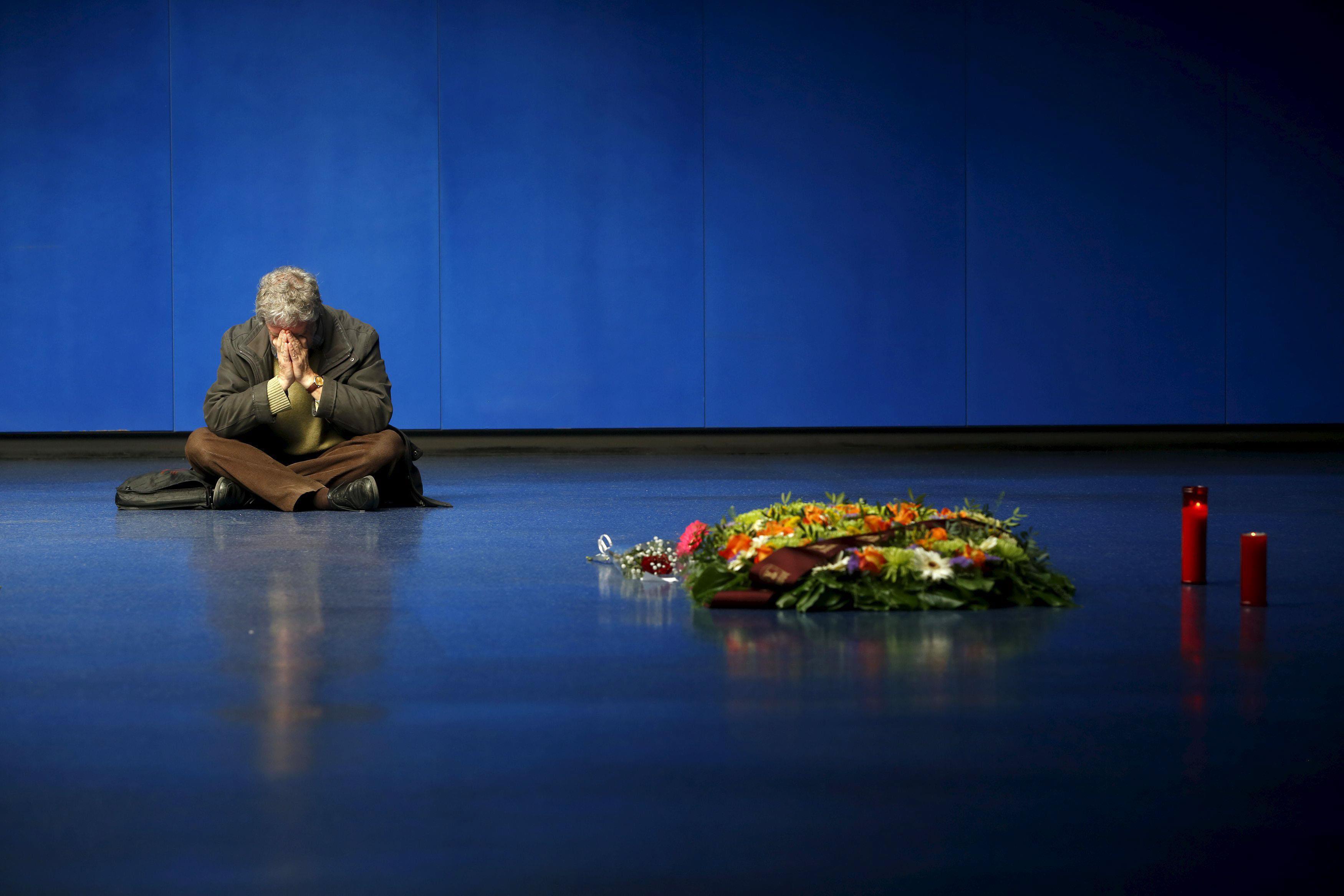 A man reacts at the Madrid train bombing memorial on the 12th anniversary of the attacks at Atocha s