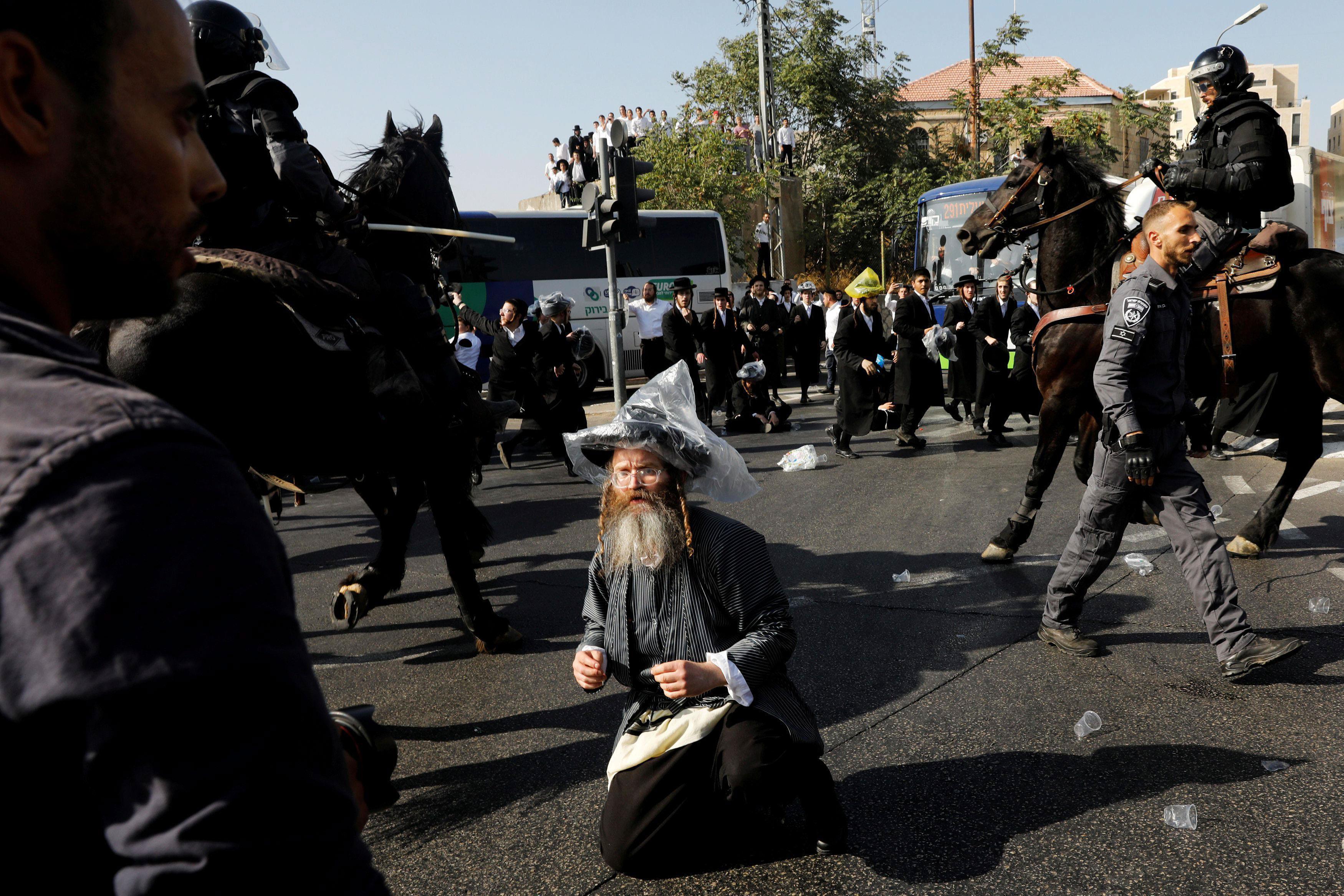 Israeli ultra-Orthodox Jewish men clash with police at a protest against the detention of a member o