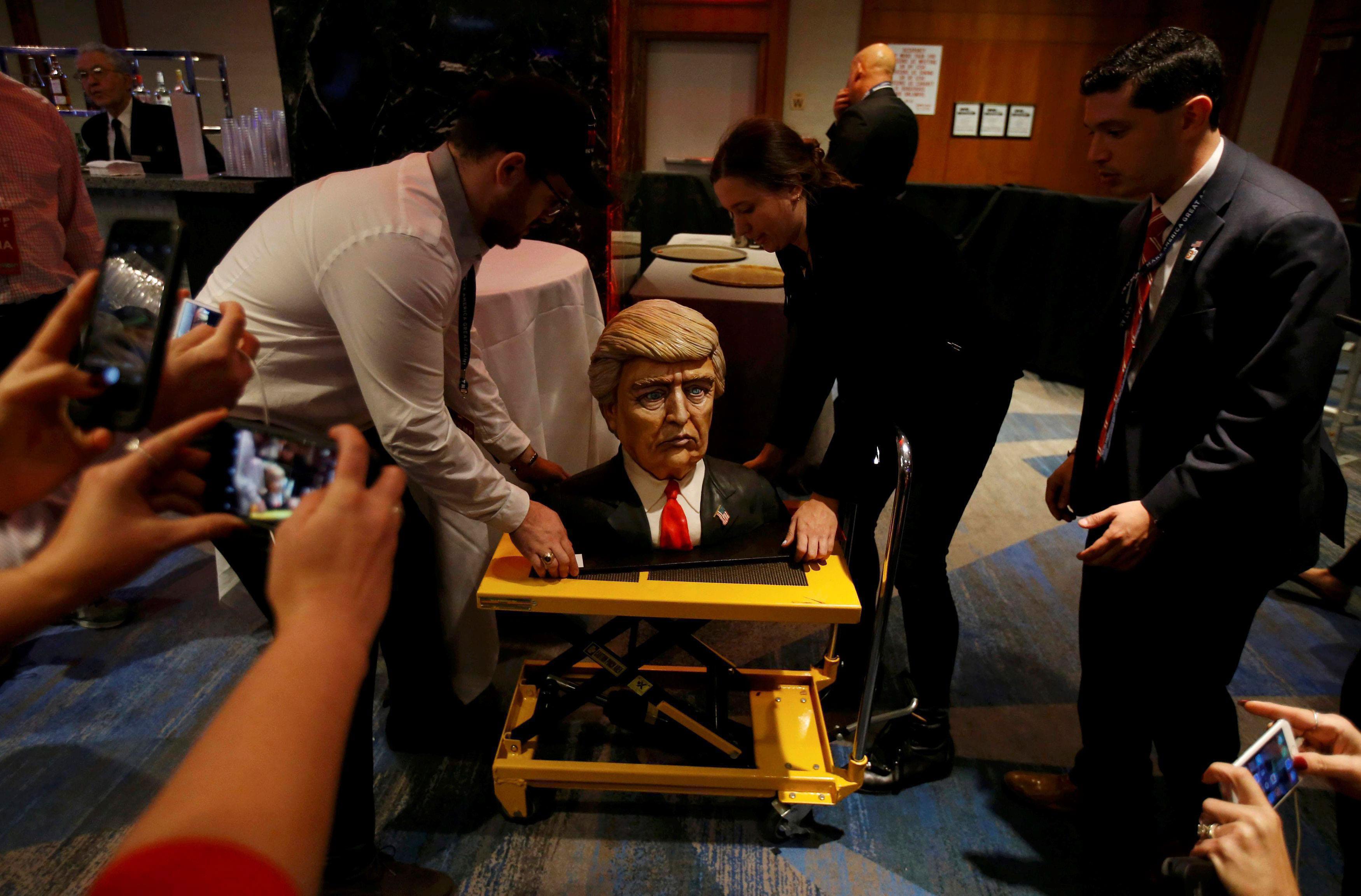 A cake in the form of Republican U.S. presidential nominee Donald Trump is brought into the hotel wh