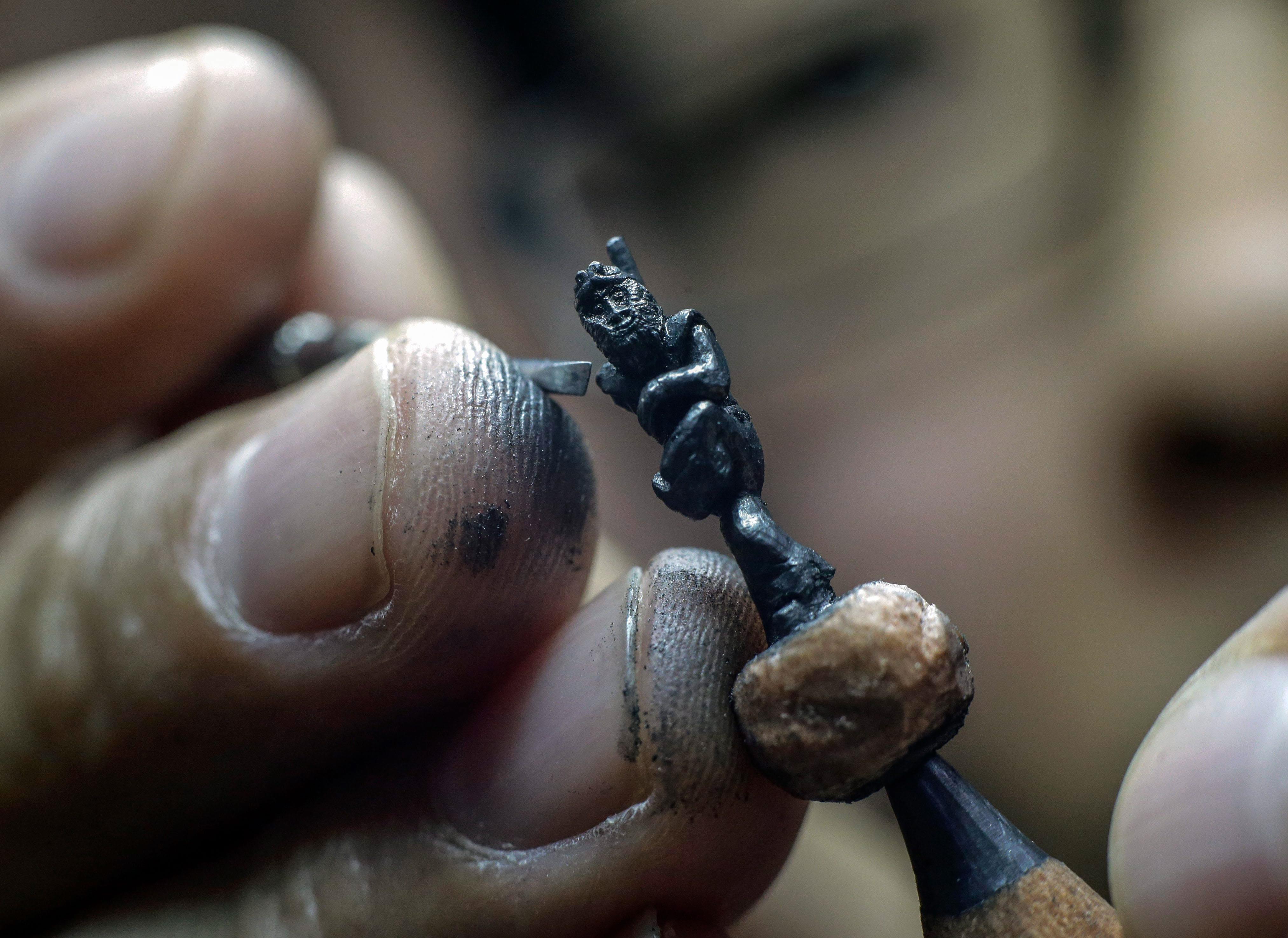 Artist carves Monkey King on the tip of pencil leads for the Chinese Lunar New Year celebrations