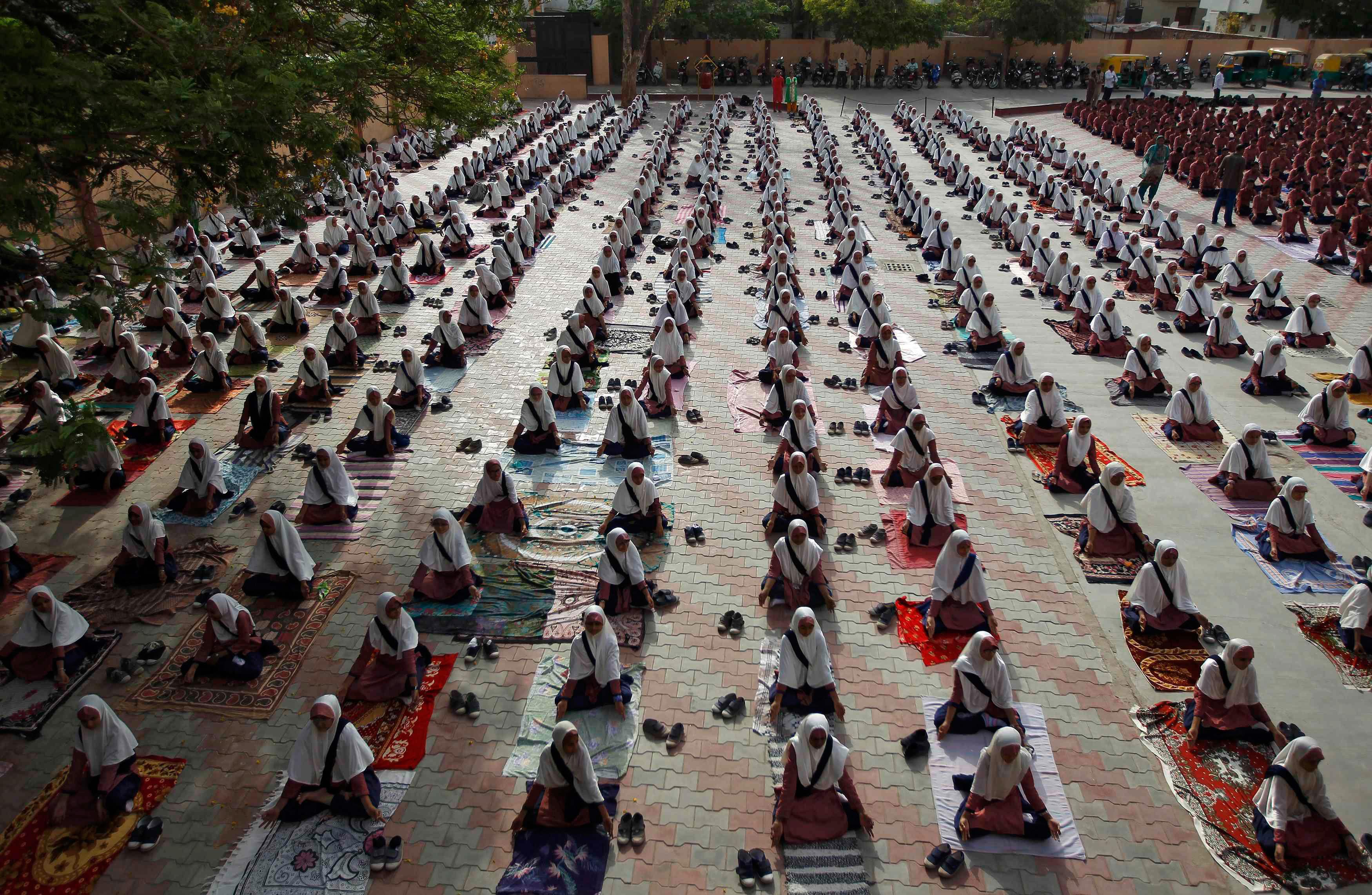 Students practice yoga during a training session ahead of World Yoga Day in Ahmedabad