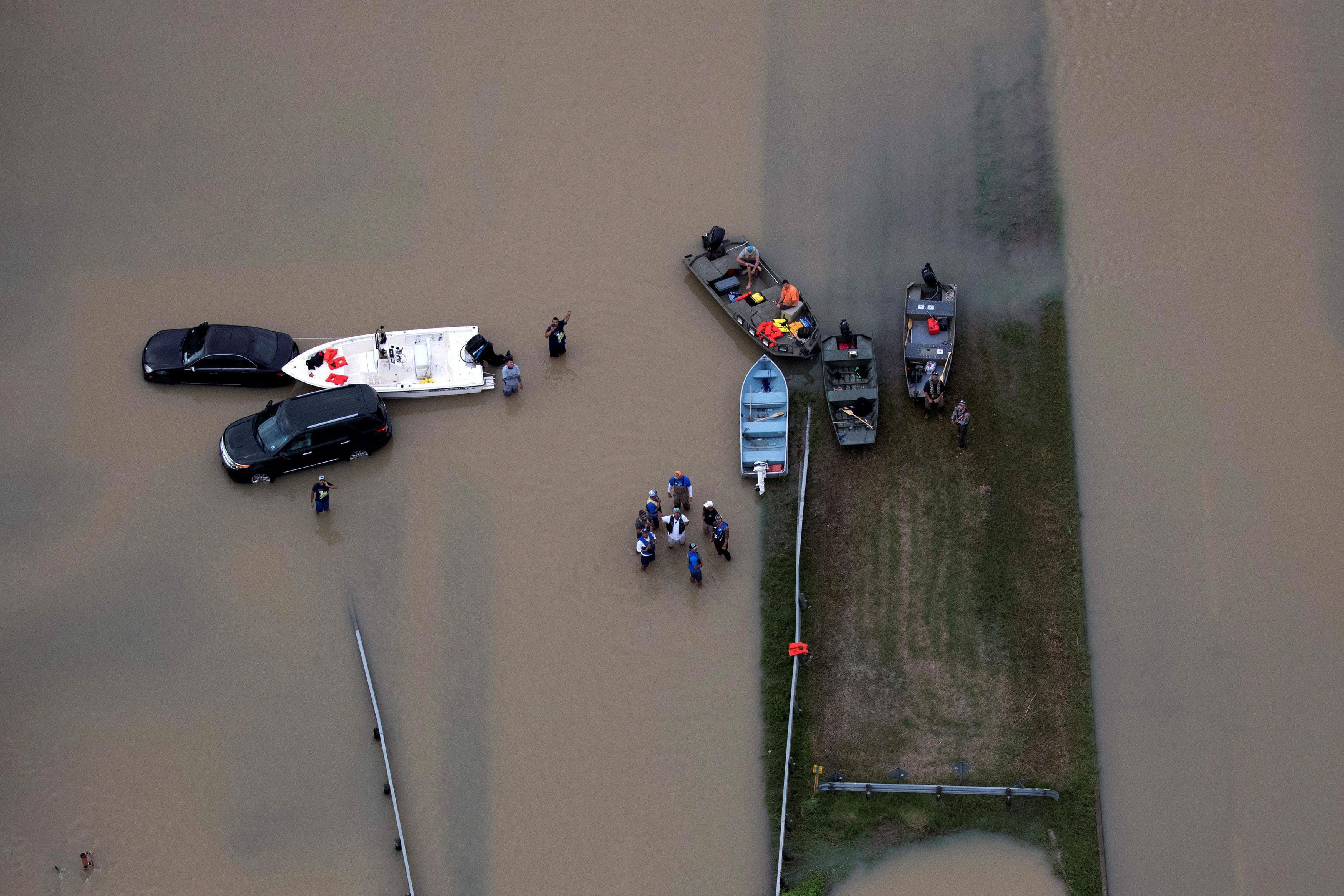 Rescue crews are seen with boats near flood waters brought by Tropical Storm Harvey in West Houston