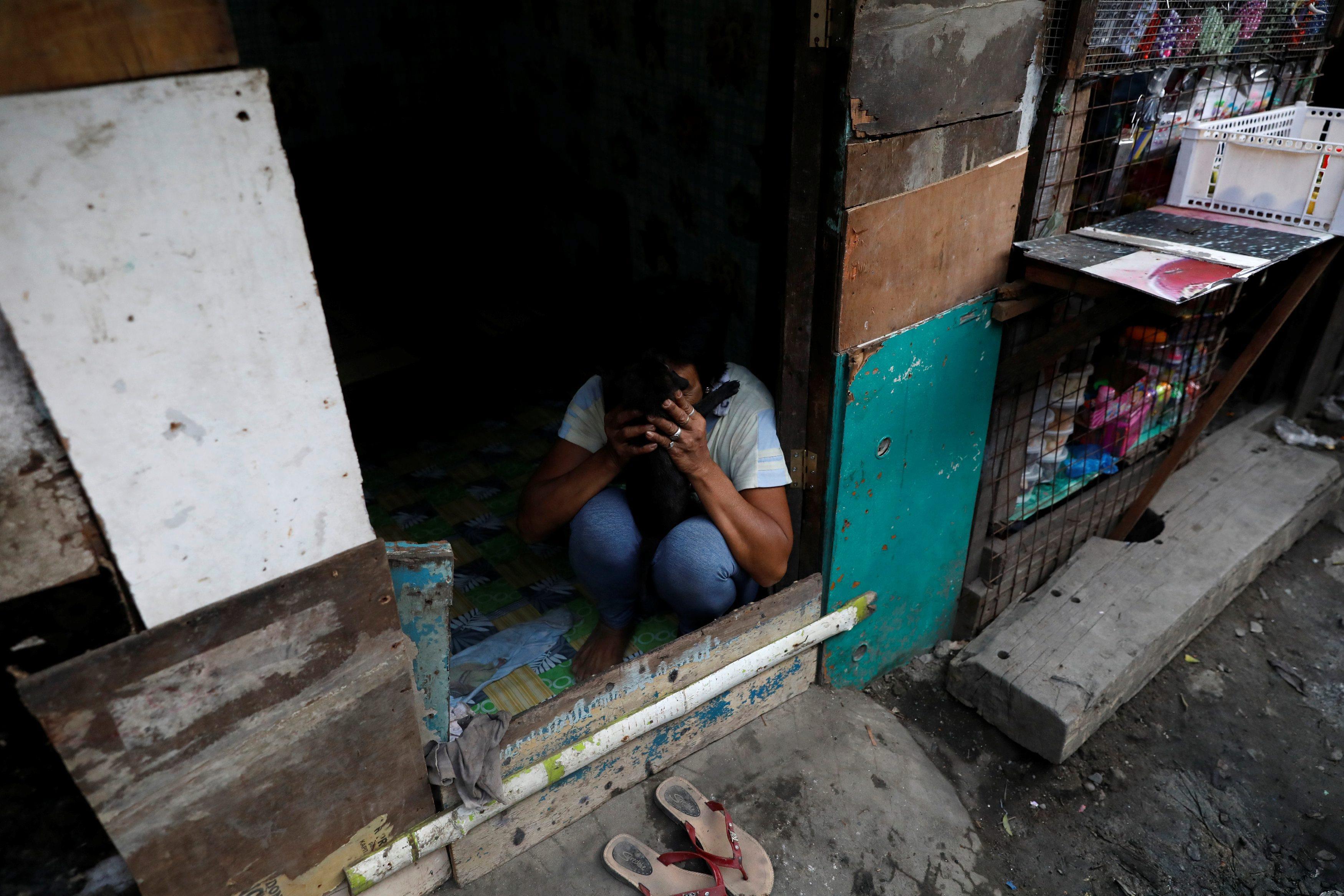 The Wider Image: Night in Manila slum revives spectre of drug war deaths