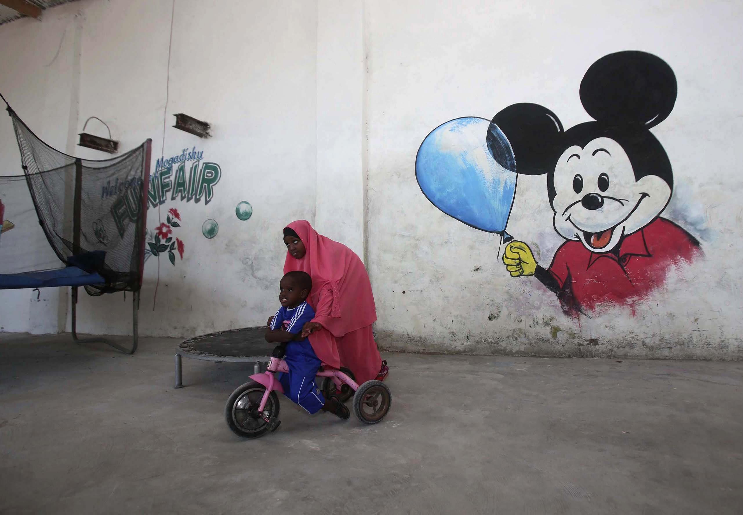 Children play at a guest hotel in Mogadishu October 10, 2013. Street lamps now brighten some of Moga