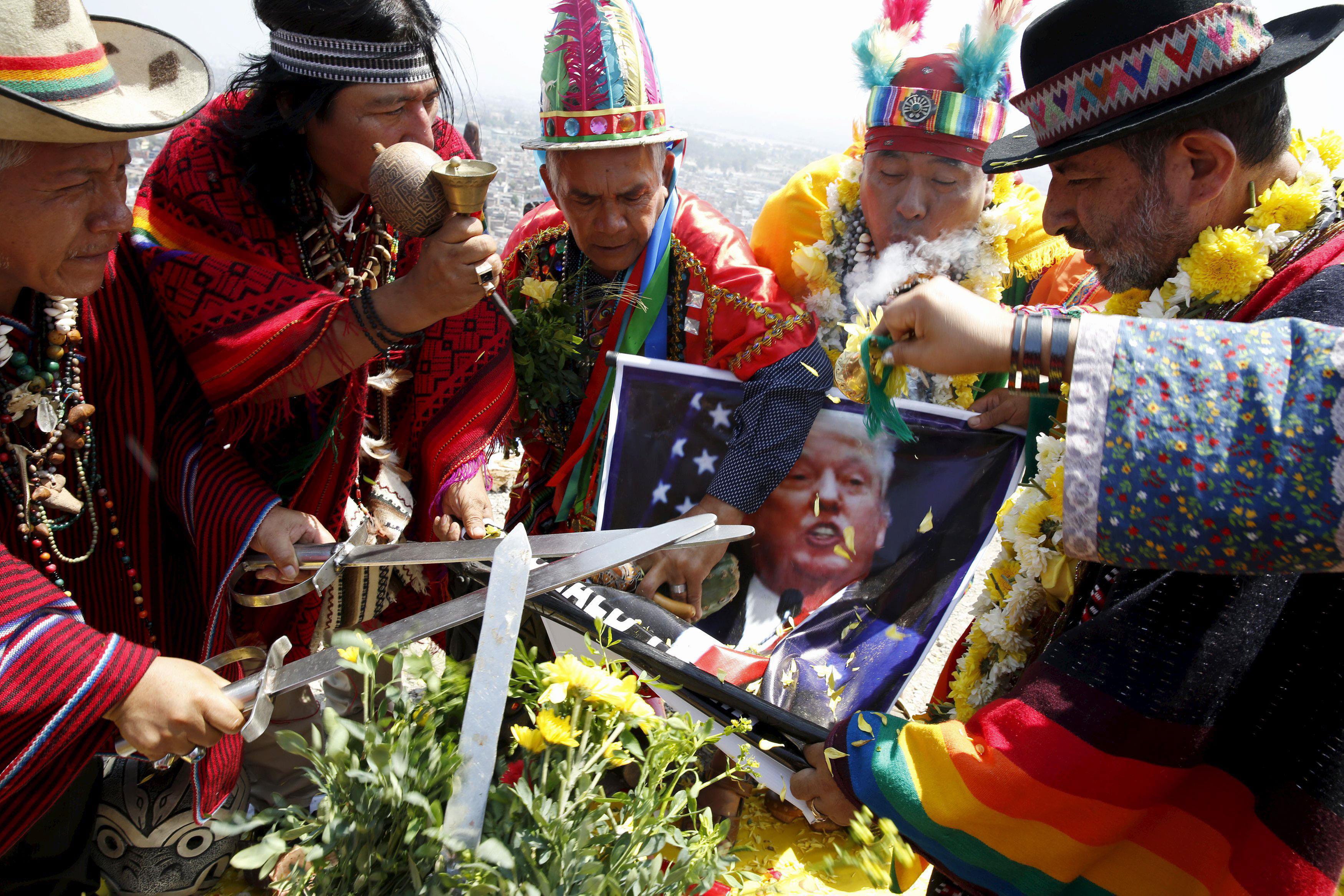 Peruvian shamans holding a poster of U.S. Republican presidential candidate Donald Trump perform a r